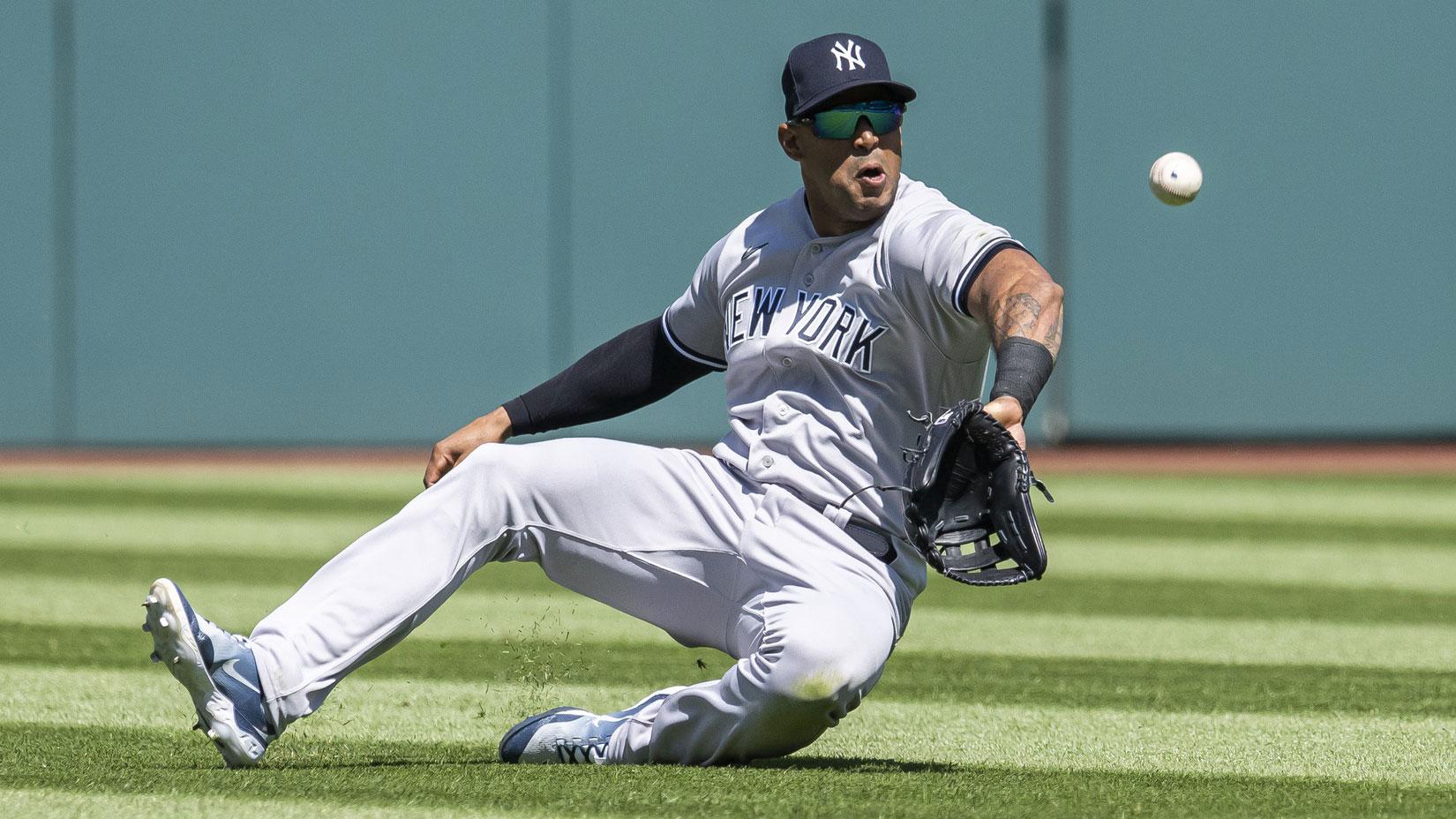 Apr 12, 2023; Cleveland, Ohio, USA; New York Yankees center fielder Aaron Hicks (31) makes a sliding attempt to catch a ball hit by Cleveland Guardians designated hitter Josh Naylor (not pictured) during the first inning at Progressive Field. Hicks was unable to make the catch. / Ken Blaze-USA TODAY Sports