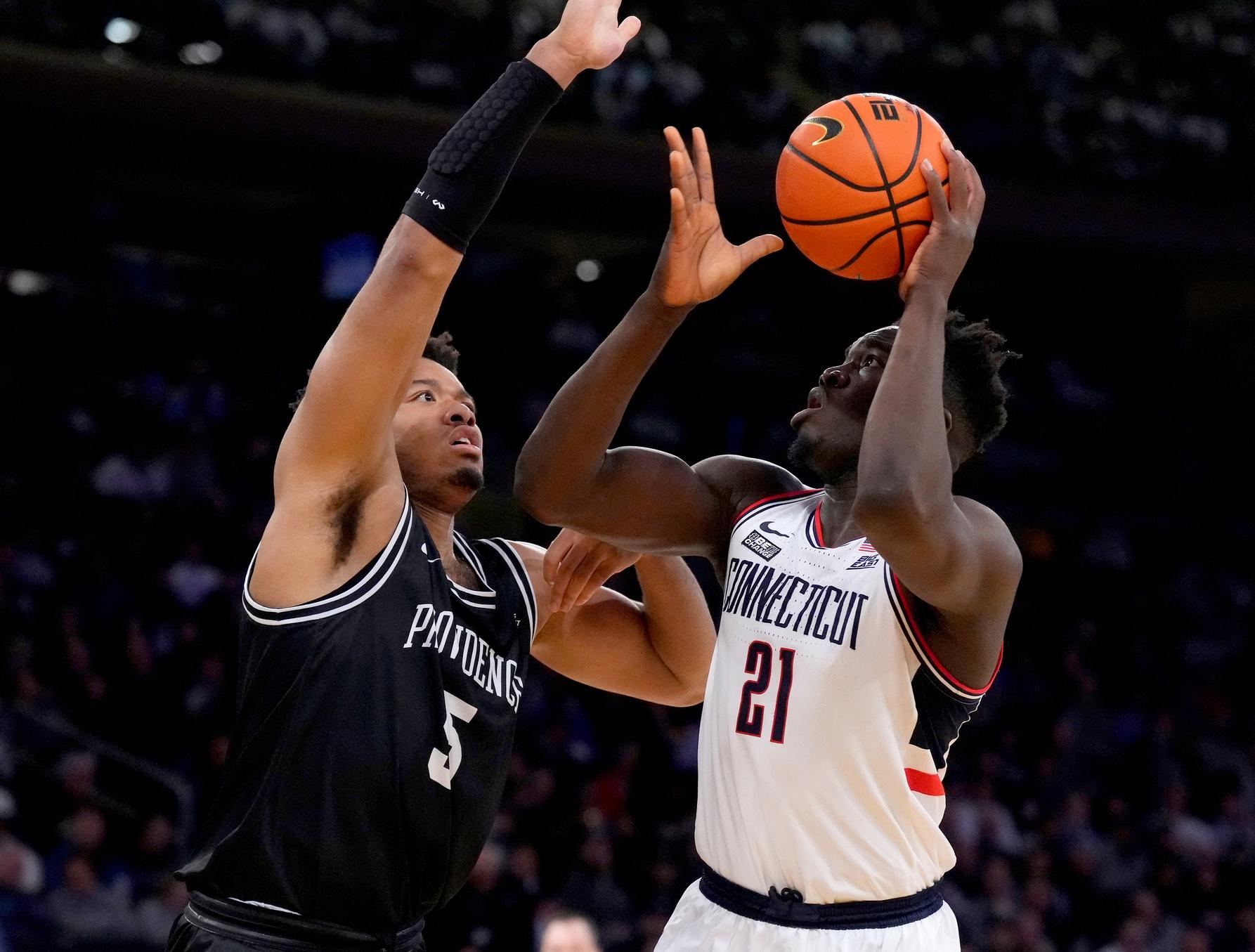 Connecticut Huskies forward Adama Sanogo (21) shoots past Providence Friars forward Ed Croswell (5) in the first half at Madison Square Garden. / Robert Deutsch-USA TODAY Sports
