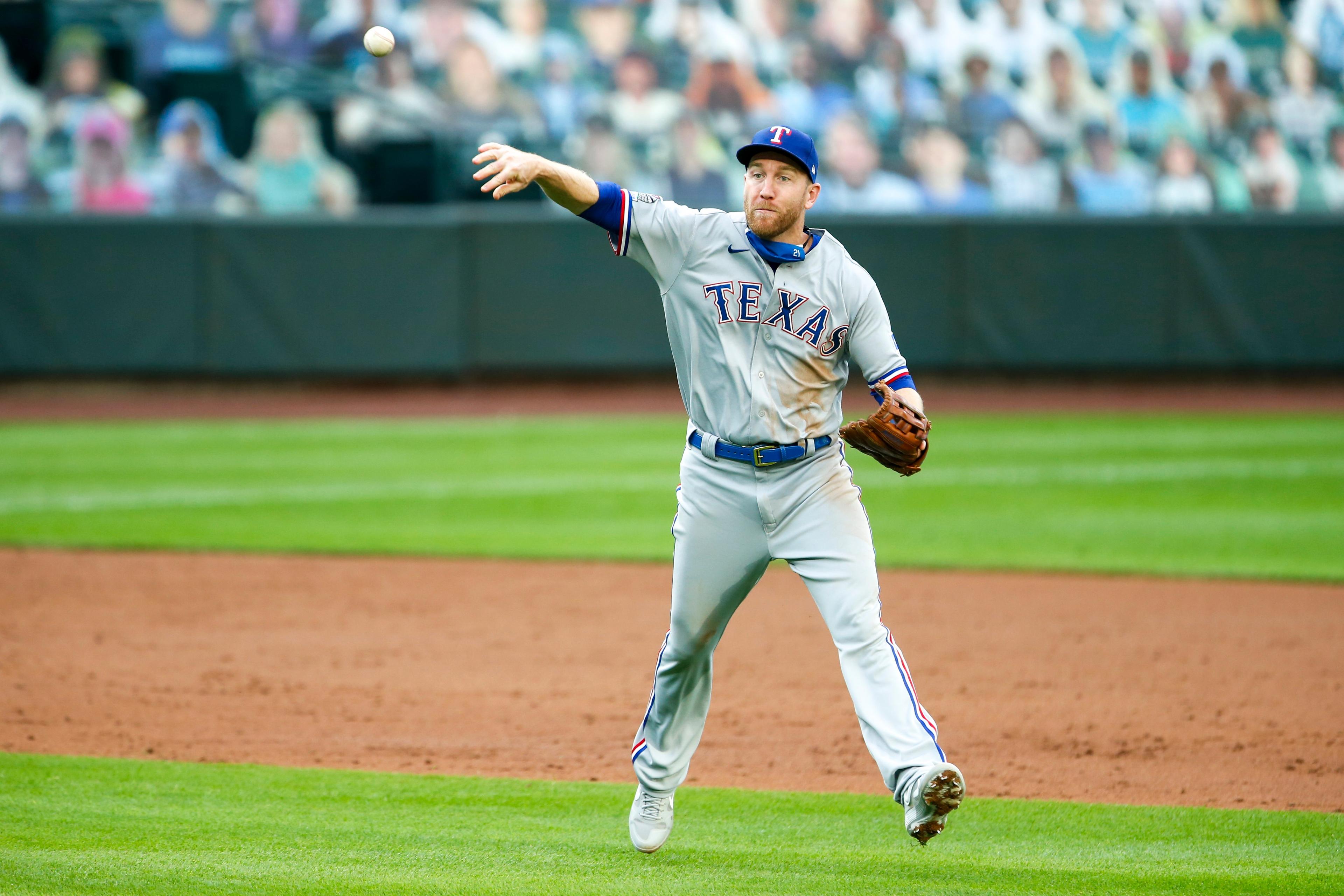 Aug 21, 2020; Seattle, Washington, USA; Texas Rangers third baseman Todd Frazier (21) throws to first base late for an infield single against the Seattle Mariners during the third inning at T-Mobile Park. / © Joe Nicholson-USA TODAY Sports