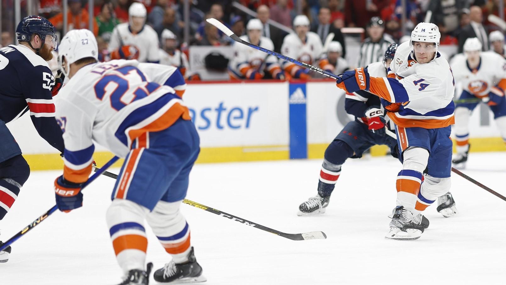 Apr 10, 2023; Washington, District of Columbia, USA; New York Islanders center Bo Horvat (14) shoots the puck as Washington Capitals defenseman Nick Jensen (3) defends in the second period at Capital One Arena. / Geoff Burke-USA TODAY Sports