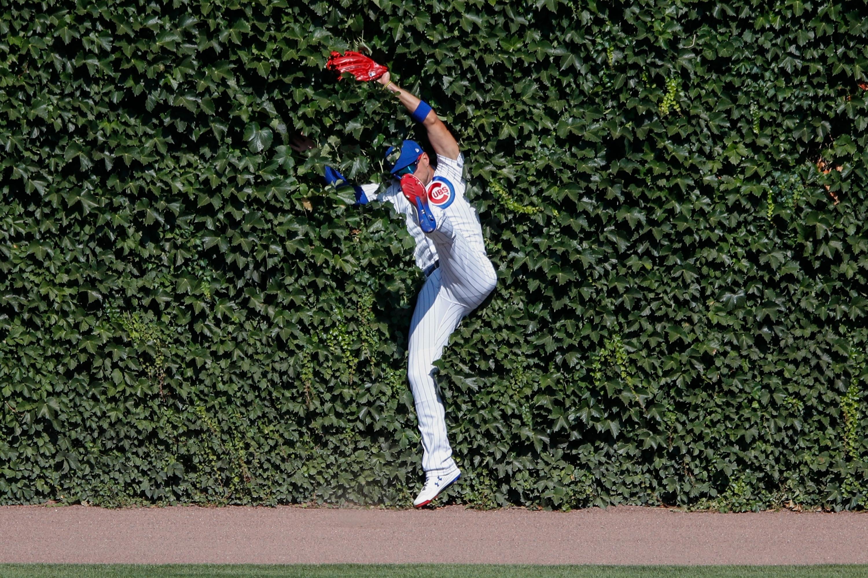 Jul 26, 2020; Chicago, Illinois, USA; Chicago Cubs center fielder Albert Almora Jr. (5) catches a fly ball hit by Milwaukee Brewers first baseman Logan Morrison (not pictured) during the ninth inning at Wrigley Field. / Kamil Krzaczynski-USA TODAY Sports