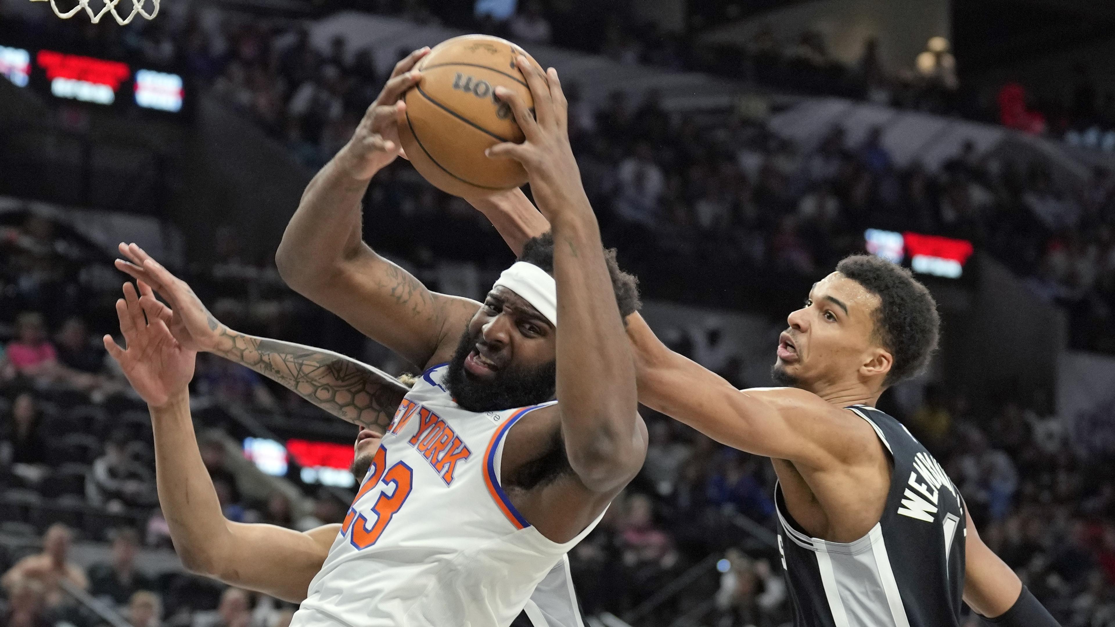 Mar 29, 2024; San Antonio, Texas, USA; New York Knicks center Mitchell Robinson (23) takes rebound away from San Antonio Spurs forward Victor Wembanyama (1) during the first half at Frost Bank Center. Mandatory Credit: Scott Wachter-USA TODAY Sports / © Scott Wachter-USA TODAY Sports