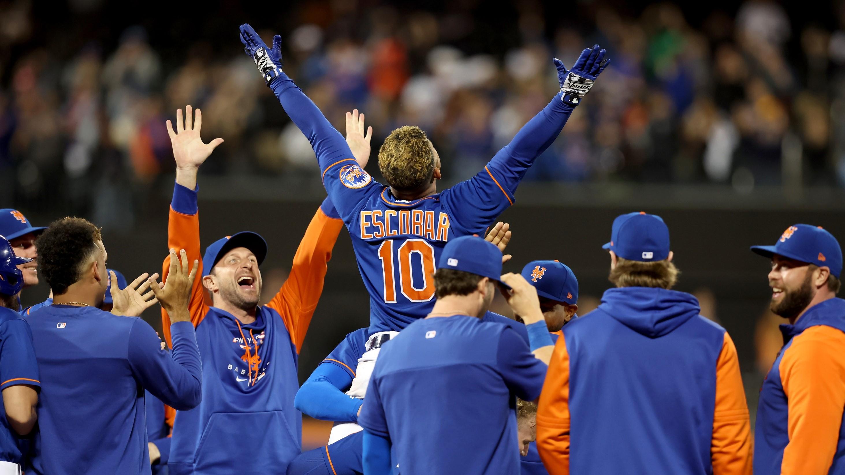 Sep 28, 2022; New York City, New York, USA; New York Mets third baseman Eduardo Escobar (10) celebrates his tenth inning game winning walkoff single against the Miami Marlins with teammates at Citi Field. / Brad Penner-USA TODAY Sports
