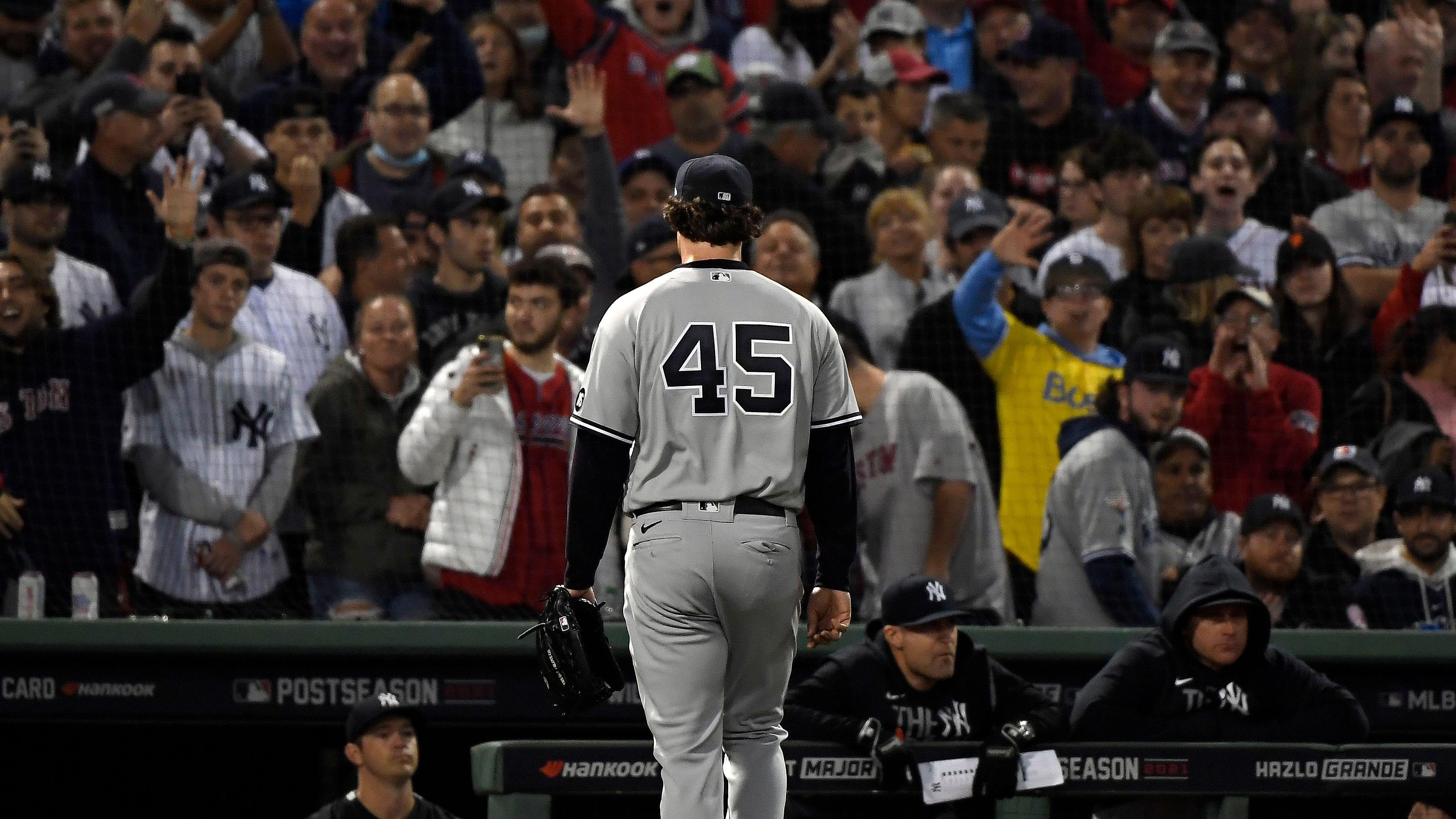 Oct 5, 2021; Boston, Massachusetts, USA; New York Yankees starting pitcher Gerrit Cole (45) walks to the dugout after being pulled against the Boston Red Sox during the third inning of the American League Wildcard game at Fenway Park. / Bob DeChiara-USA TODAY Sports