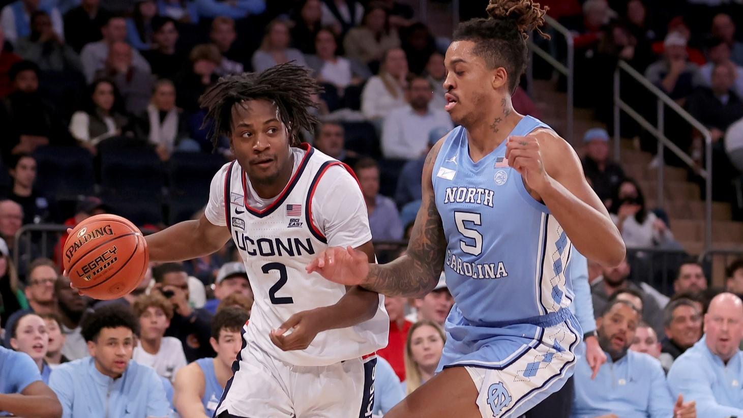 Dec 5, 2023; New York, New York, USA; Connecticut Huskies guard Tristen Newton (2) controls the ball against North Carolina Tar Heels forward Armando Bacot (5) during the first half at Madison Square Garden. / Brad Penner-USA TODAY Sports
