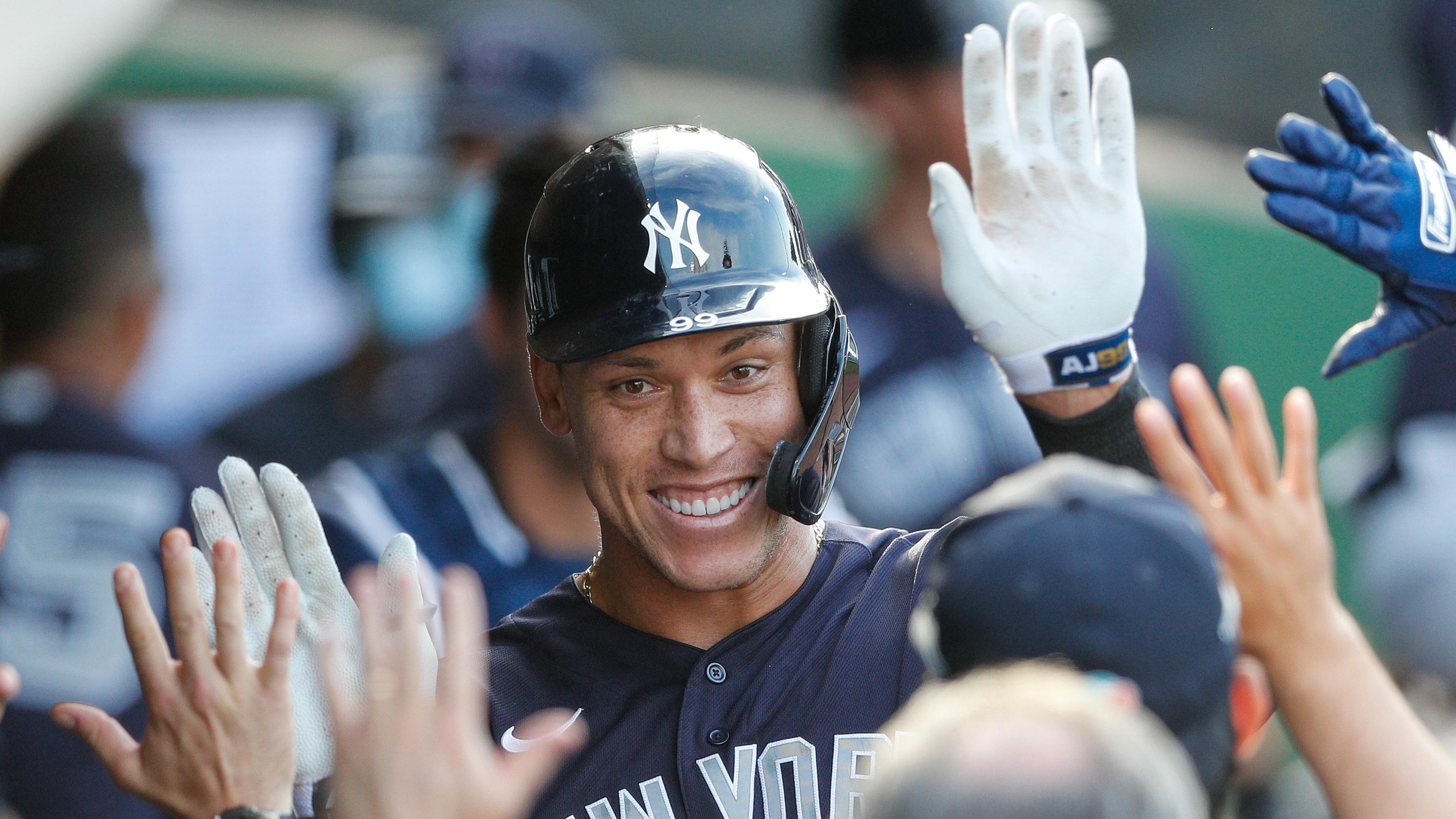 Mar 25, 2021; Clearwater, Florida, USA; New York Yankees right fielder Aaron Judge (99) its congratulated by his teammates in the dugout after hitting a two-run home run in the first inning against the Philadelphia Phillies during spring training at BayCare Ballpark. Mandatory Credit: Nathan Ray Seebeck-USA TODAY Sports / © Nathan Ray Seebeck-USA TODAY Sports