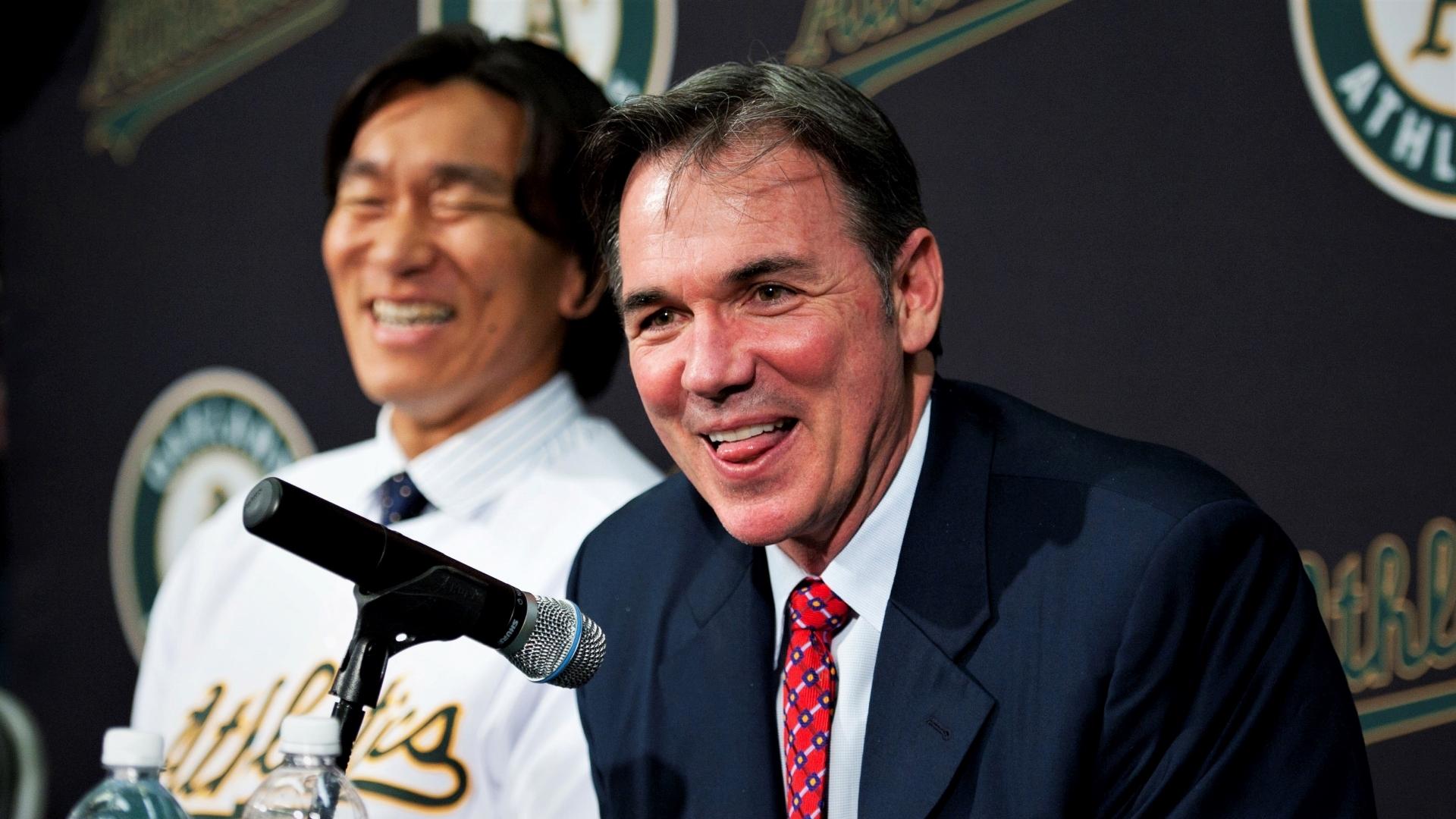 Oakland Athletics general manager Billy Beane (right) smiles while addressing the media as designated hitter Hideki Matsui (left) looks on during a press conference following Matsui signing with the Athletics at Oakland-Alameda County Coliseum. Mandatory Credit: Kyle Terada-USA TODAY Sports