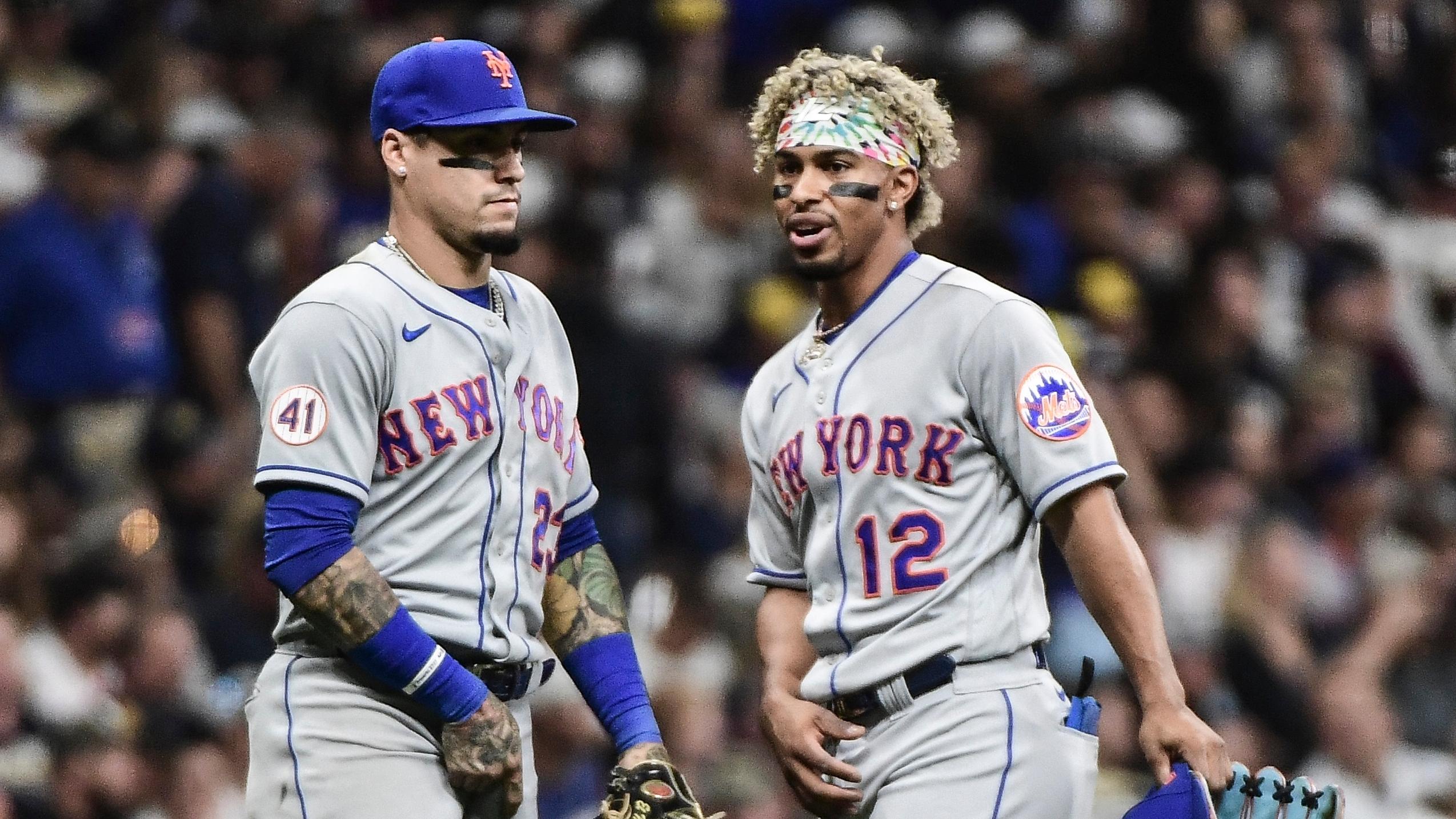 New York Mets shortstop Francisco Lindor (12) talks to second baseman Javier Baez (23) between inning during the game against the Milwaukee Brewers at American Family Field. / Benny Sieu - USA TODAY Sports