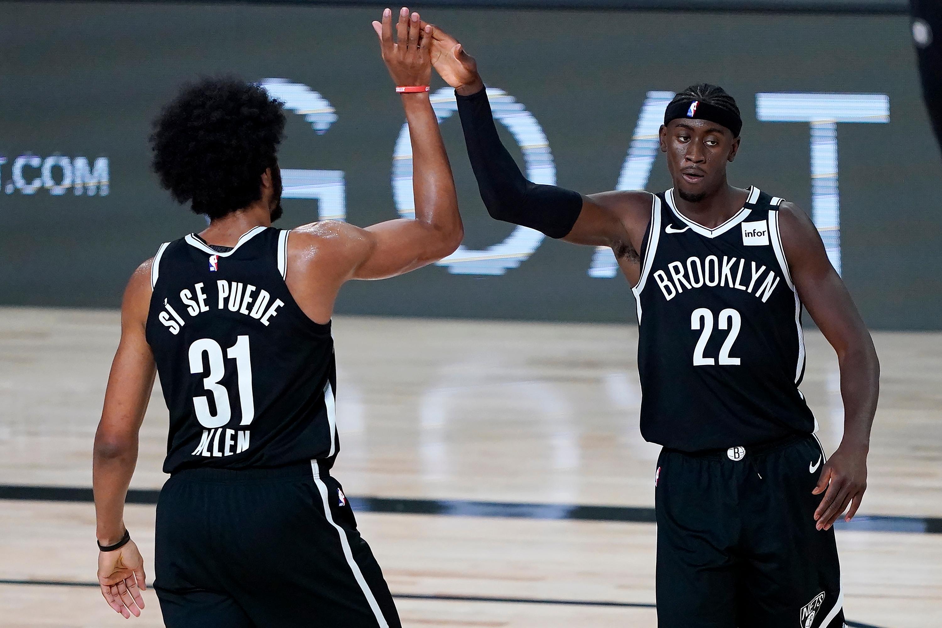 Brooklyn Nets' Jarrett Allen (31) and Caris LeVert (22) react after a play against the Sacramento Kings during the first half of an NBA basketball game at The Arena. / Ashley Landis- Pool Photo
