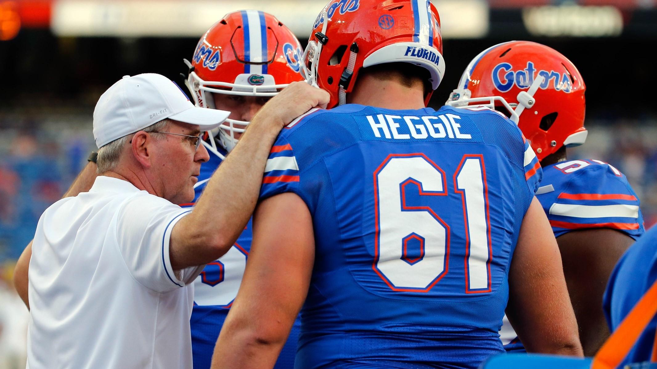 Sep 17, 2016; Gainesville, FL, USA; Florida Gators offensive line coach Mike Summers talks with offensive lineman Brett Heggie (61) and teammates prior to the game against the North Texas Mean Green at Ben Hill Griffin Stadium. / Kim Klement-USA TODAY Sports