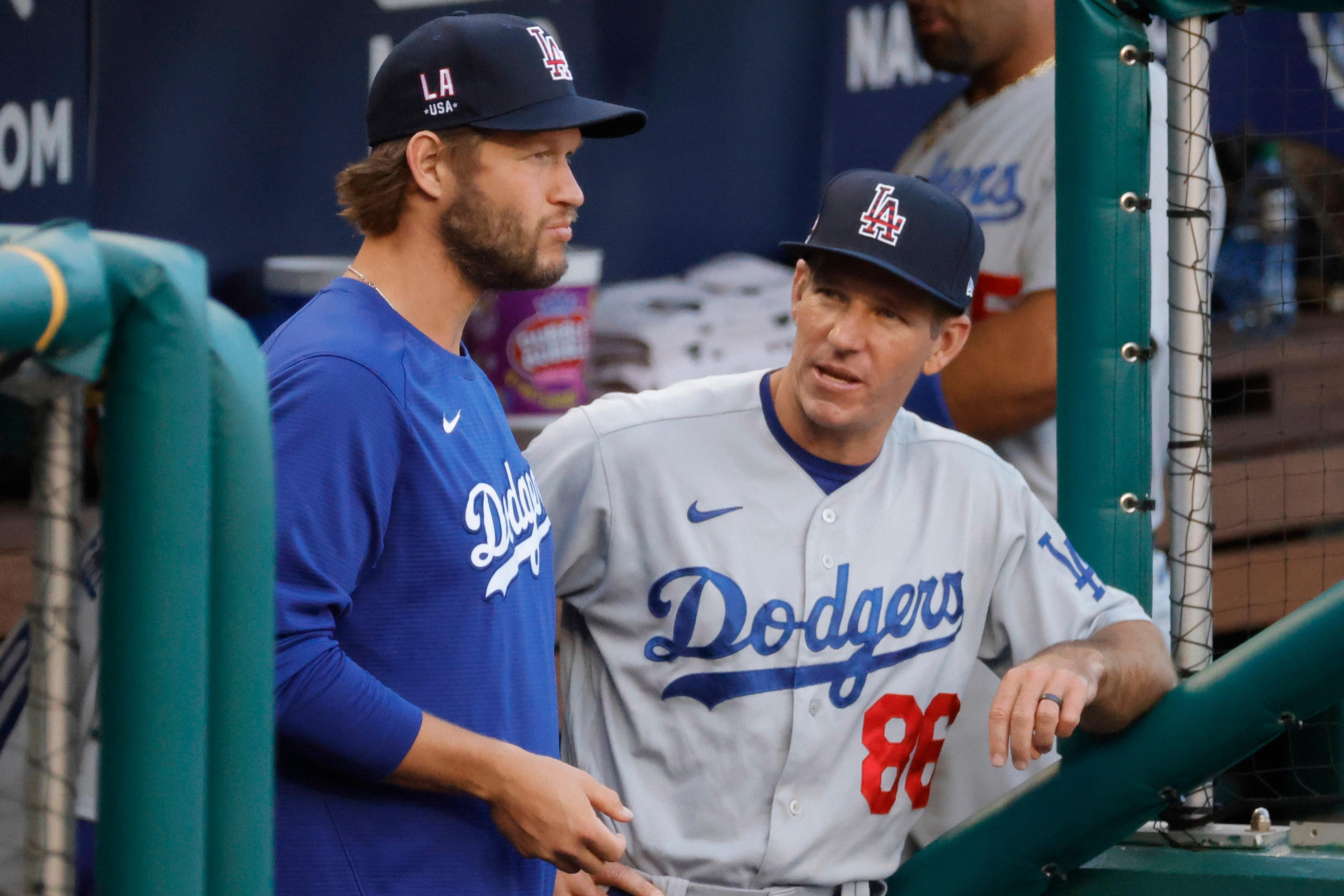 Jul 1, 2021; Washington, District of Columbia, USA; Los Angeles Dodgers starting pitcher Clayton Kershaw (L) talks with Dodgers first base coach Clayton McCullough (86) in the dugout before the dodgers' game against the Washington Nationals at Nationals Park. / Geoff Burke-USA TODAY Sports