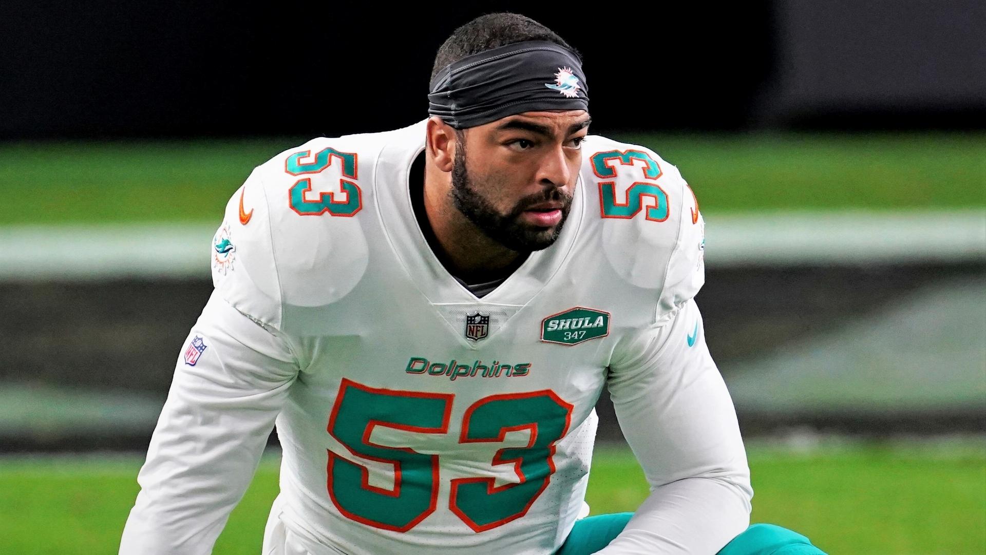 Kyle Van Noy kneels in white Dolphins jersey / Kirby Lee/USA TODAY