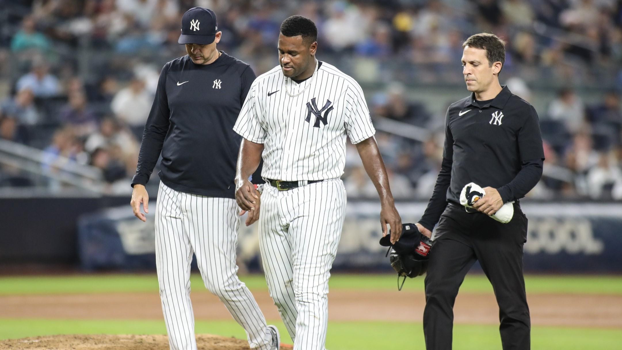 Sep 8, 2023; Bronx, New York, USA; New York Yankees starting pitcher Luis Severino (40) walks off the field with manager Aaron Boone (17) after getting injured in the fifth inning against the Milwaukee Brewers at Yankee Stadium. / Wendell Cruz-USA TODAY Sports