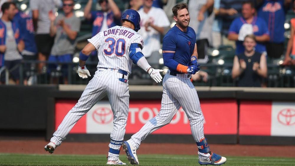 New York Mets second baseman Jeff McNeil (right) celebrates his walk-off single against the Milwaukee Brewers with right fielder Michael Conforto (30) at Citi Field. / Brad Penner-USA TODAY Sports