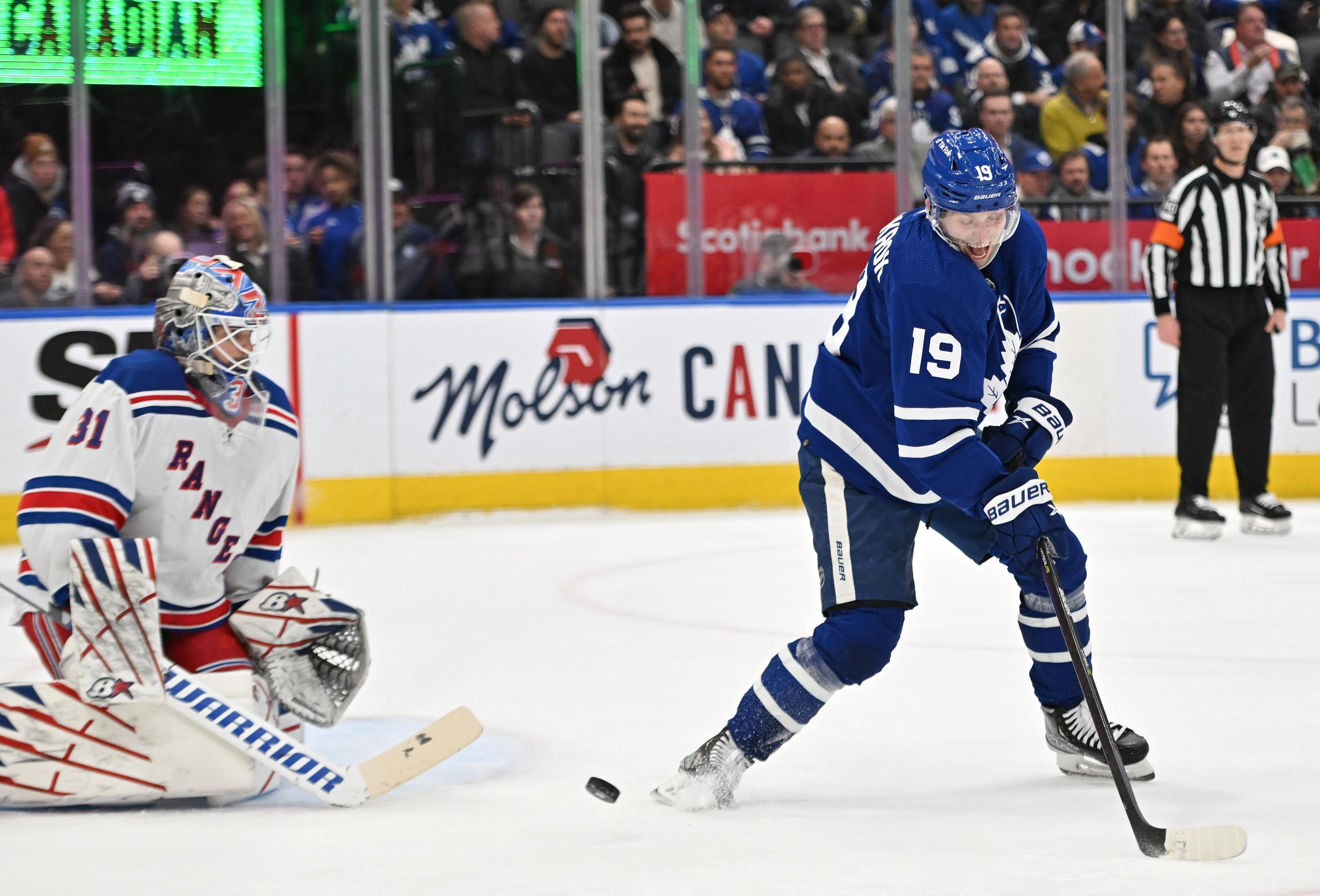 Toronto Maple Leafs forward Calle Jarnkrok (19) deflects the puck in front of New York Rangers goalie Igor Shesterkin (31) in the first period at Scotiabank Arena. / Dan Hamilton-USA TODAY Sports