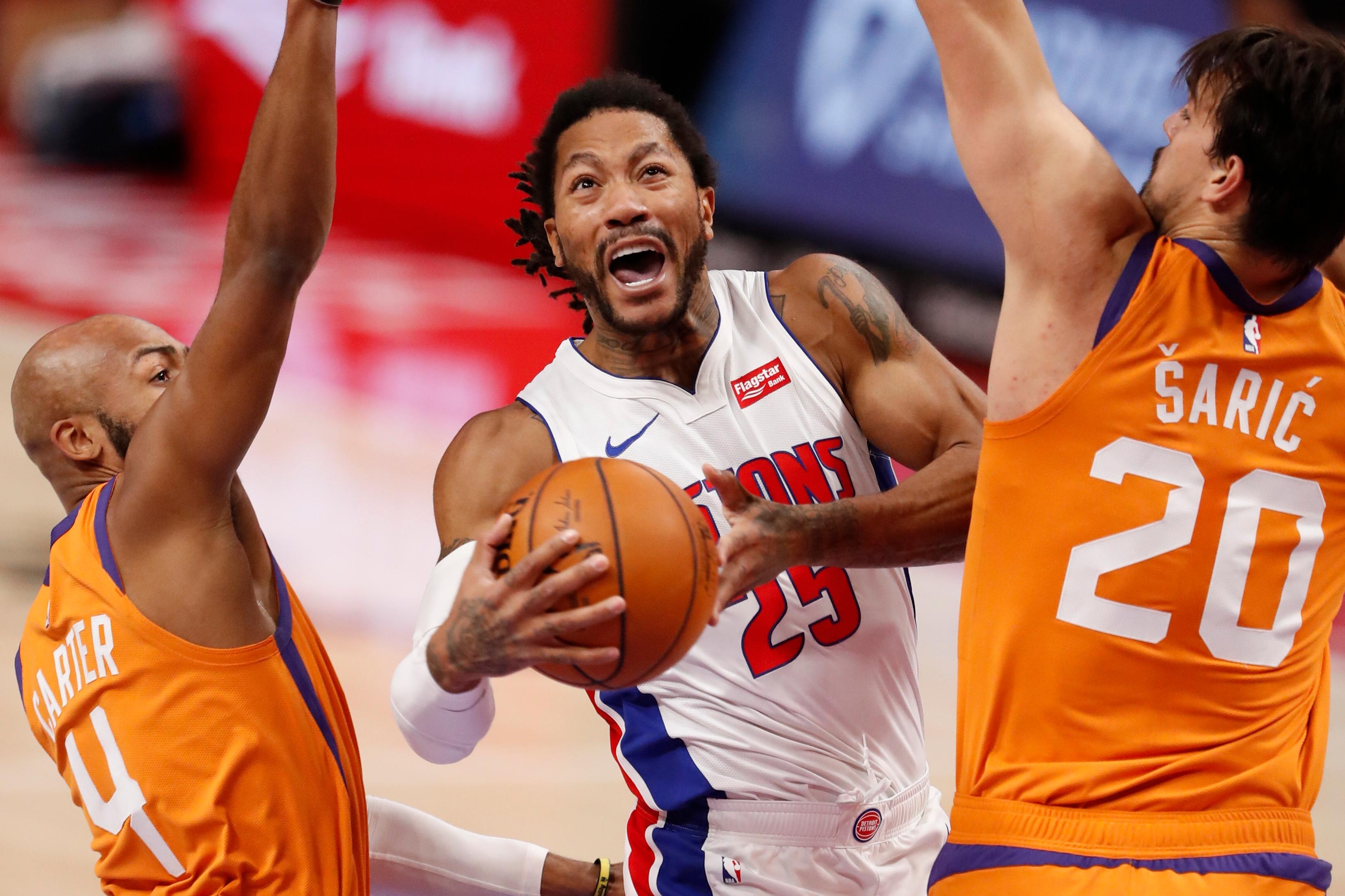 Jan 8, 2021; Detroit, Michigan, USA; Detroit Pistons guard Derrick Rose (25) goes up for a shot against Phoenix Suns guard Jevon Carter (4) and forward Dario Saric (20) during the second quarter at Little Caesars Arena. / Raj Mehta-USA TODAY Sports