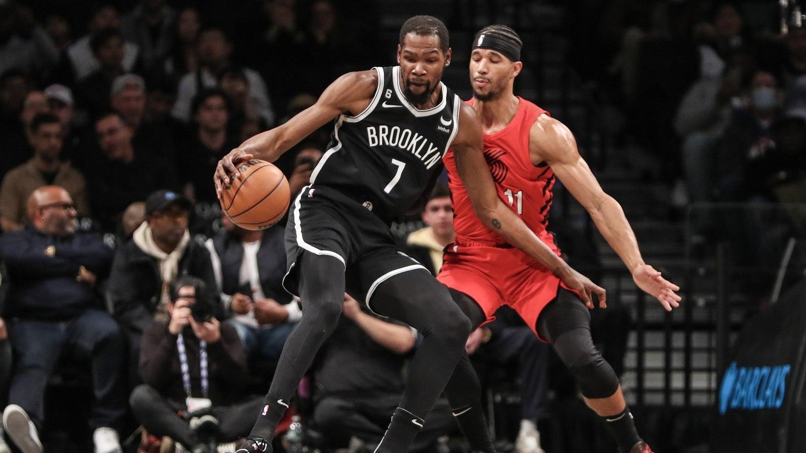 Brooklyn Nets forward Kevin Durant looks to spin away from Portland Trail Blazers guard Josh Hart. / Wendell Cruz-USA TODAY Sports