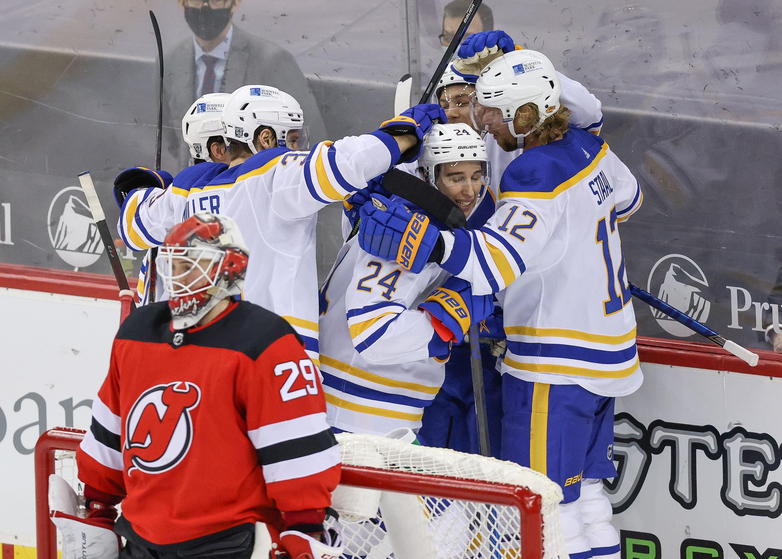 Feb 23, 2021; Newark, New Jersey, USA; Buffalo Sabres center Dylan Cozens (24) celebrates his goal past New Jersey Devils goaltender Mackenzie Blackwood (29) with teammates during the third period at Prudential Center. / © Vincent Carchietta-USA TODAY Sports
