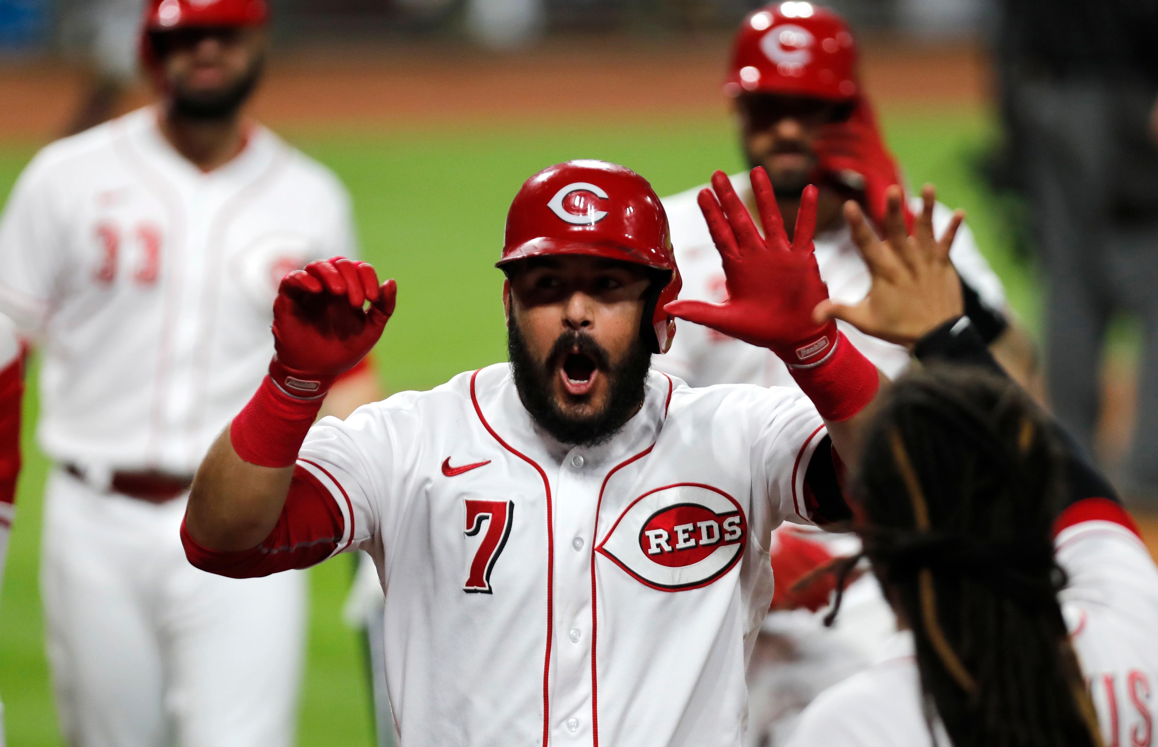 Sep 21, 2020; Cincinnati, Ohio, USA; Cincinnati Reds third baseman Eugenio Suarez (7) reacts with teammates after hitting a two-run home run against the Milwaukee Brewers during the sixth inning at Great American Ball Park. x / David Kohl-USA TODAY Sports