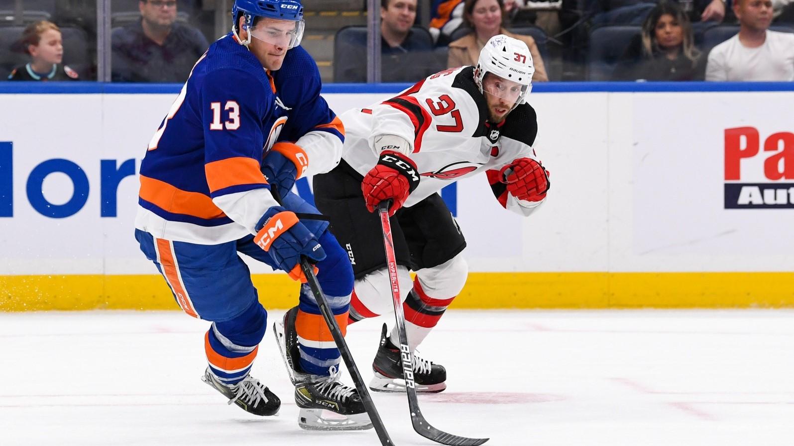 Oct 6, 2023; Elmont, New York, USA; New York Islanders Center Mathew Barzal (13) makes a move around New Jersey Devils Center Justin Dowling (37) during the third period at UBS Arena / Dennis Schneidler-USA TODAY Sports