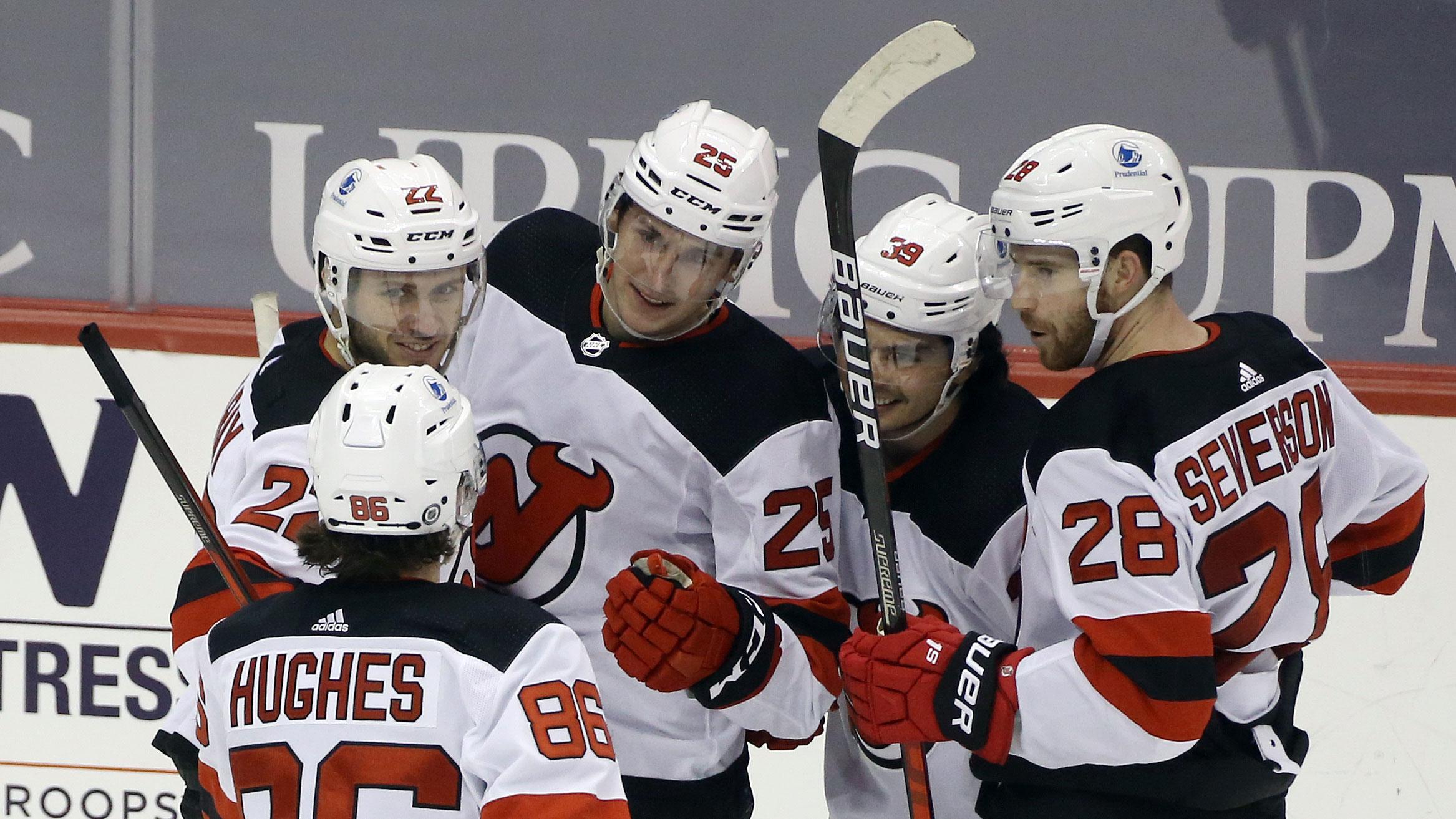 Apr 20, 2021; Pittsburgh, Pennsylvania, USA; New Jersey Devils left wing Nolan Foote (25) celebrates his first career NHL goal with teammates against the Pittsburgh Penguins during the third period at PPG Paints Arena. Pittsburgh won 7-6. / Charles LeClaire-USA TODAY Sports