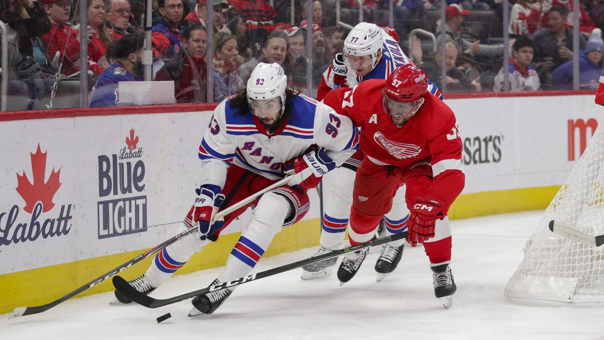 Feb 23, 2023; Detroit, Michigan, USA; New York Rangers center Mika Zibanejad (93) and Detroit Red Wings left wing David Perron (57) fight for control of the puck during the second period at Little Caesars Arena. / Brian Bradshaw Sevald-USA TODAY Sports
