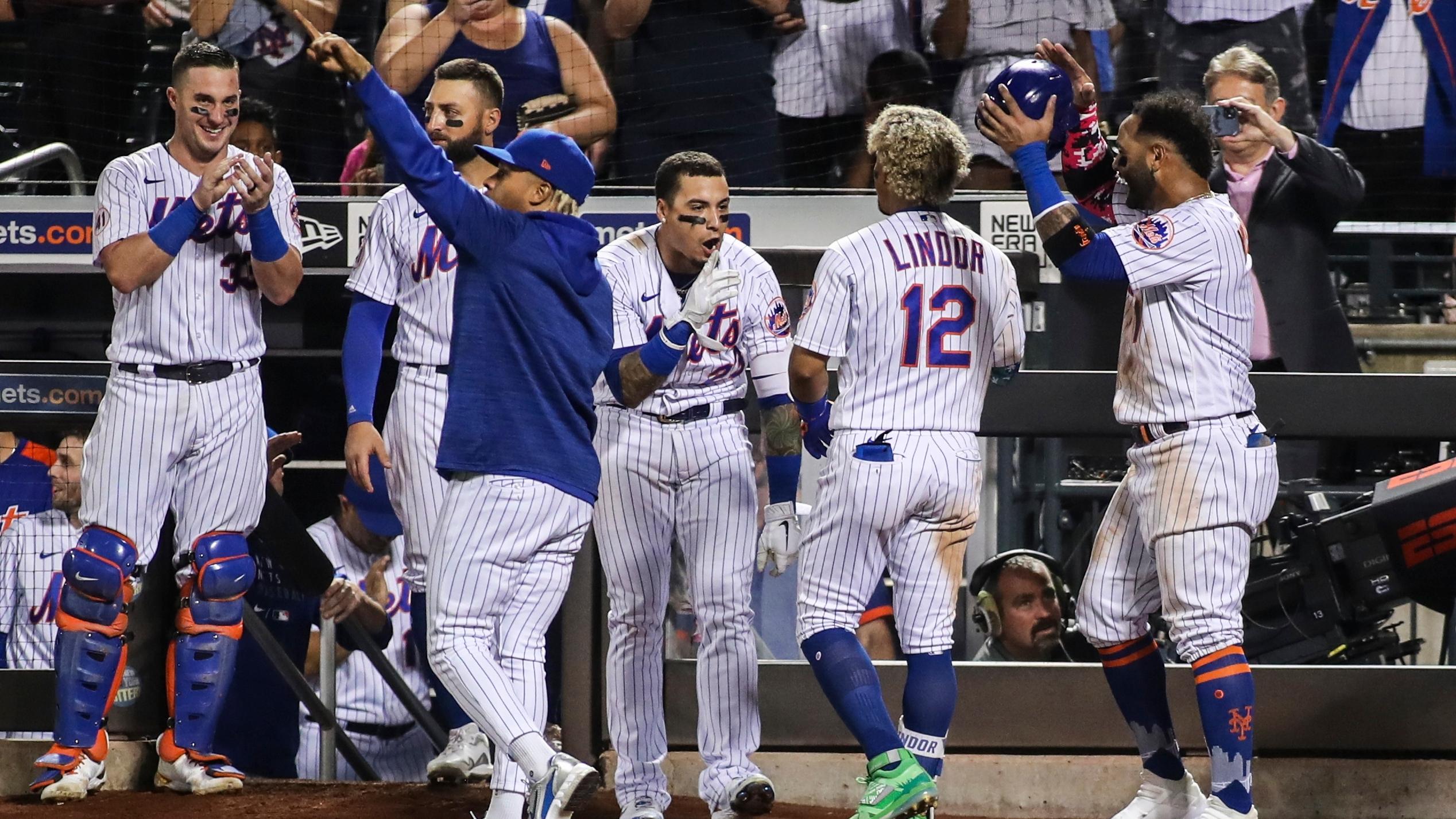 Sep 12, 2021; New York City, New York, USA; New York Mets shortstop Francisco Lindor (12) is greeted by his teammates after hitting his third home run of the game in the eighth inning against the New York Yankees at Citi Field. / Wendell Cruz-USA TODAY Sports