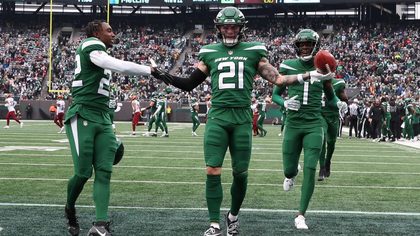 Dec 24, 2023; East Rutherford, New Jersey, USA; New York Jets safety Ashtyn Davis (21) celebrates his fumble recovery with safety Tony Adams (22) and cornerback Sauce Gardner (1) during the first half against the Washington Commanders at MetLife Stadium. / Vincent Carchietta-USA TODAY Sports
