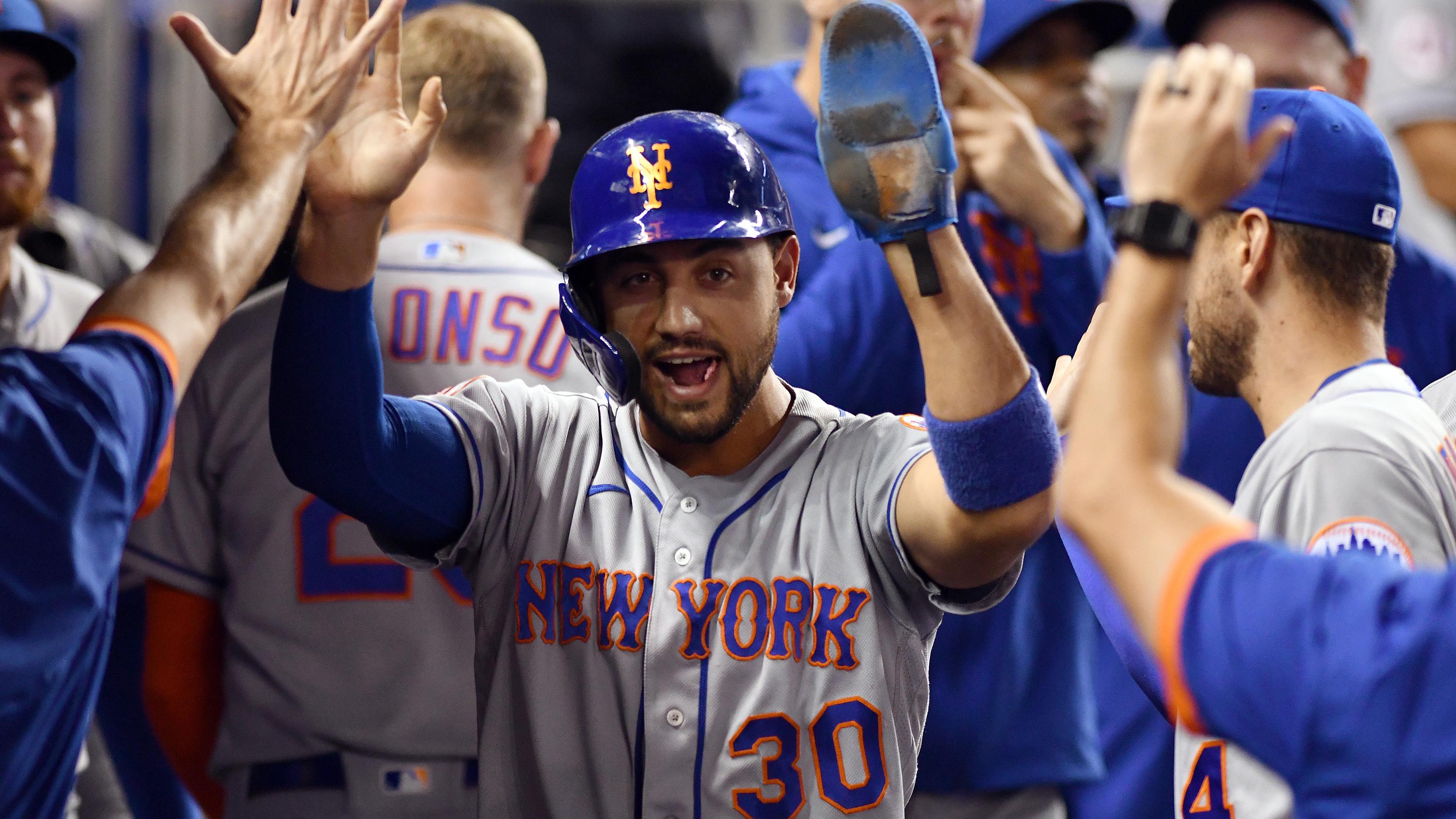 Aug 4, 2021; Miami, Florida, USA; New York Mets right fielder Michael Conforto (30) celebrates with teammates after scoring a run against the Miami Marlins in the second inning at loanDepot Park. / Jim Rassol-USA TODAY Sports