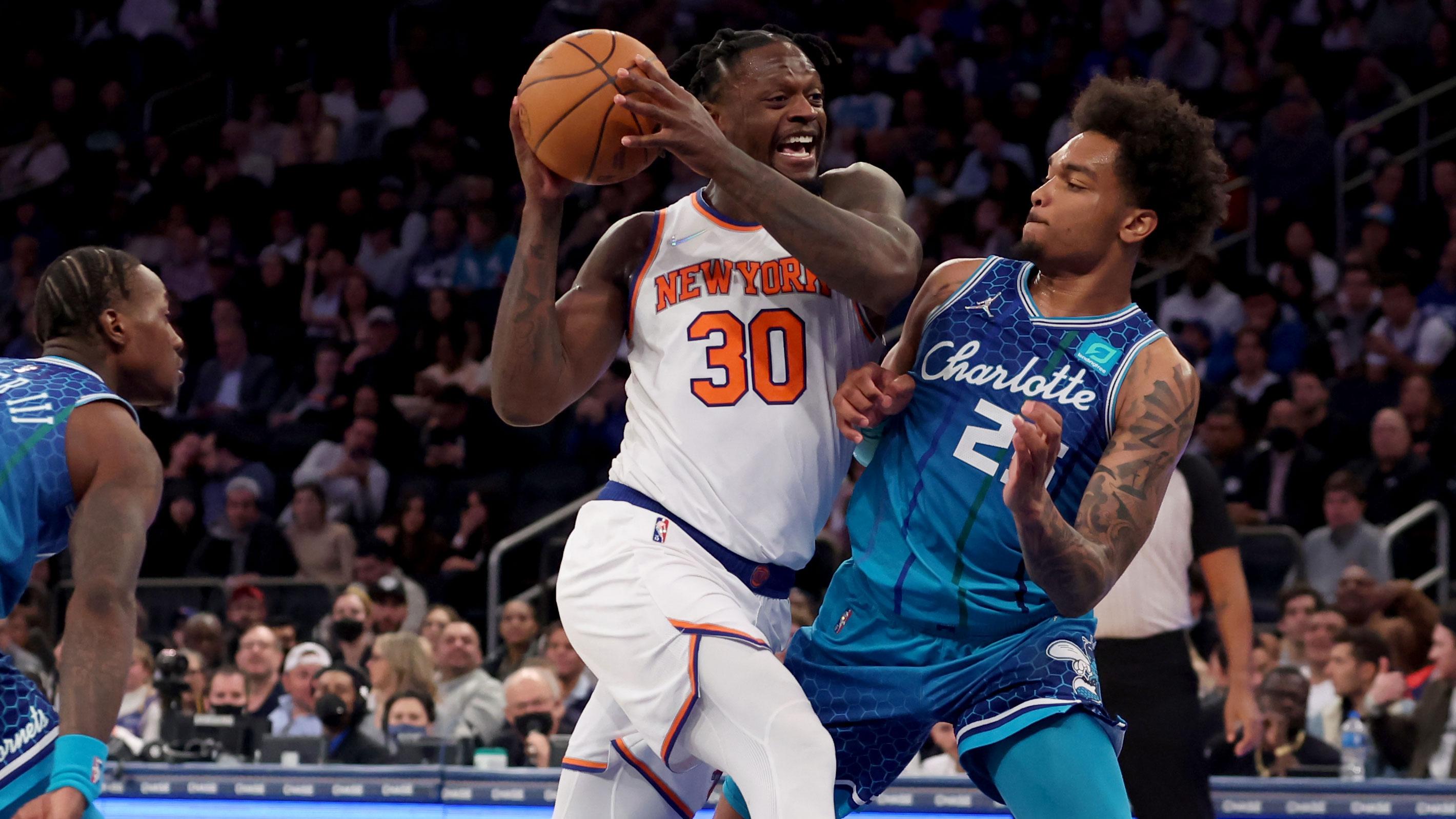 Mar 30, 2022; New York, New York, USA; New York Knicks forward Julius Randle (30) drives to the basket against Charlotte Hornets guard Terry Rozier (3) and forward P.J. Washington (25) during the fourth quarter at Madison Square Garden. / Brad Penner-USA TODAY Sports