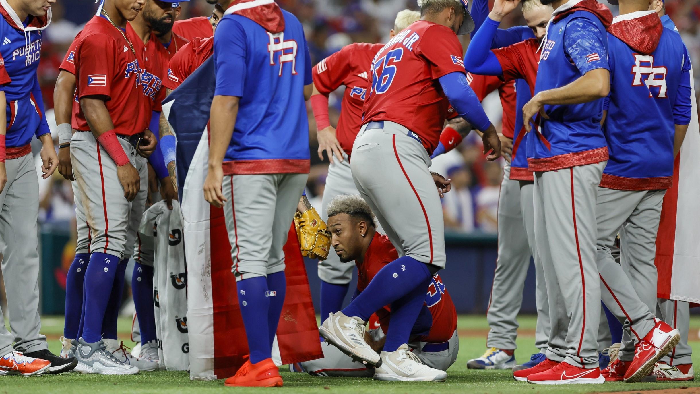 Mar 15, 2023; Miami, Florida, USA; Puerto Rico relief pitcher Edwin Diaz (39) looks on while sitting on the field after an apparent leg injury during the team celebration after winning the game against Dominican Republic at LoanDepot Park. / Sam Navarro-USA TODAY Sports