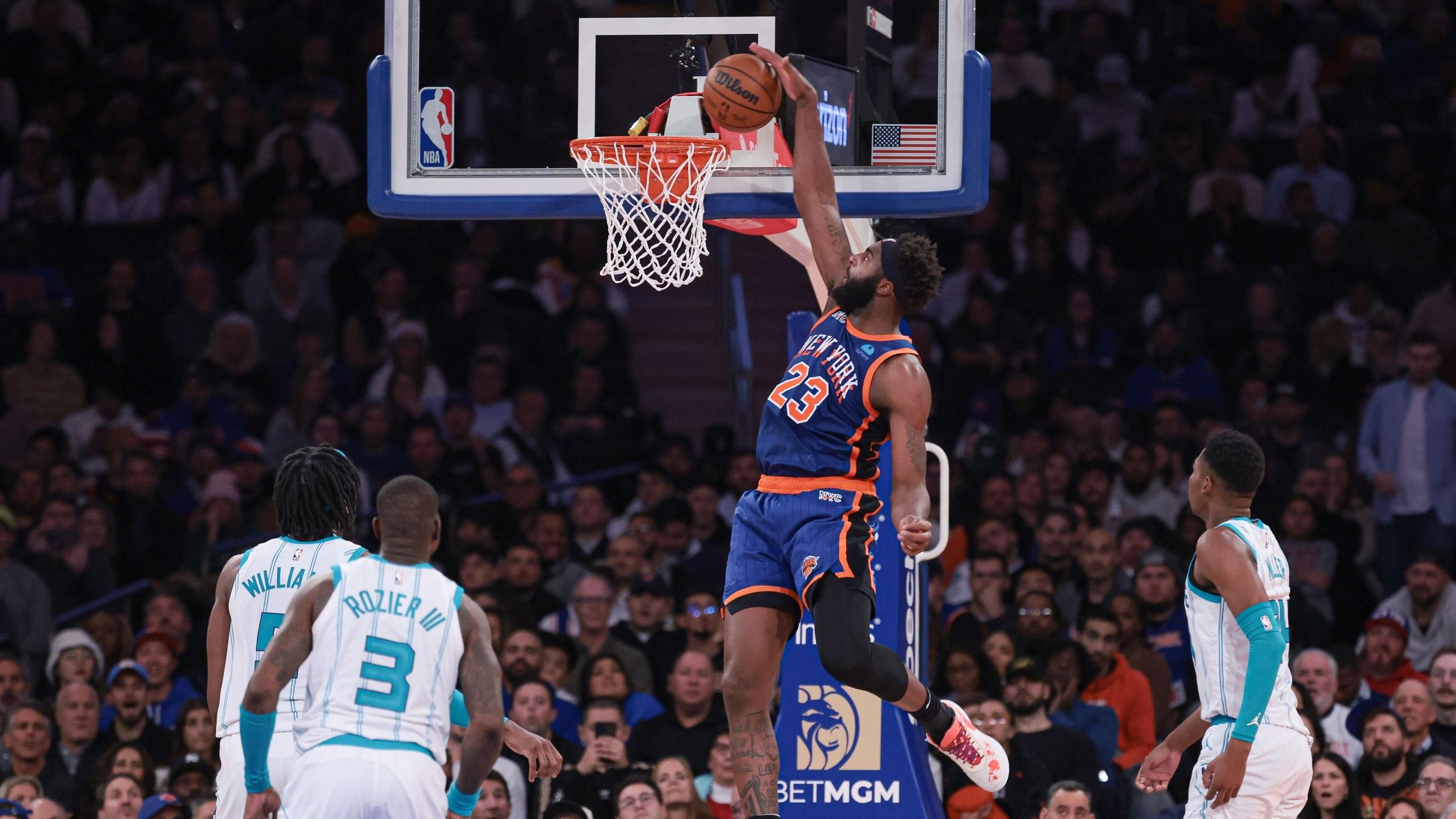 Nov 28, 2023; New York, New York, USA; New York Knicks center Mitchell Robinson (23) dunks in front of Charlotte Hornets center Mark Williams (5) and guard Terry Rozier (3) and forward Brandon Miller (24) during the second half at Madison Square Garden. / Vincent Carchietta-USA TODAY Sports