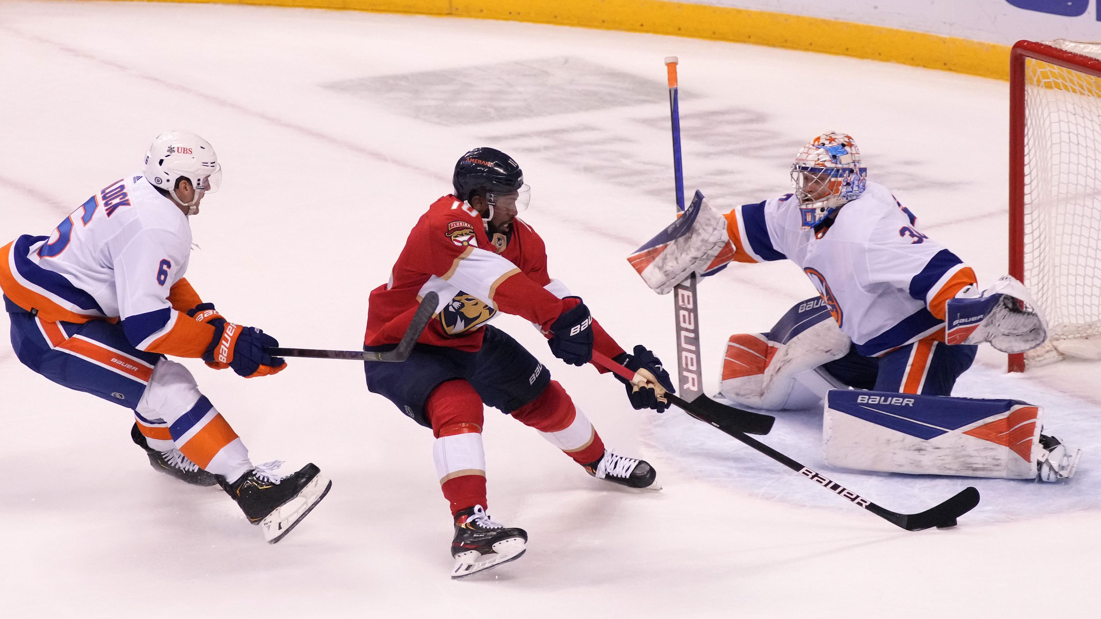 Oct 16, 2021; Sunrise, Florida, USA; Florida Panthers left wing Anthony Duclair (10) takes a shot on goal between New York Islanders defenseman Ryan Pulock (6) and New goaltender Ilya Sorokin (30) during the second period at FLA Live Arena. / Jasen Vinlove-USA TODAY Sports