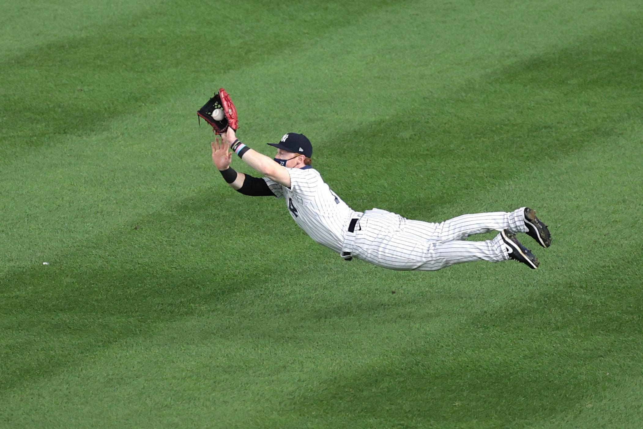 Sep 1, 2020; Bronx, New York, USA; New York Yankees right fielder Clint Frazier (77) catches the ball during the fifth inning against the Tampa Bay Rays at Yankee Stadium. / © Vincent Carchietta-USA TODAY Sports