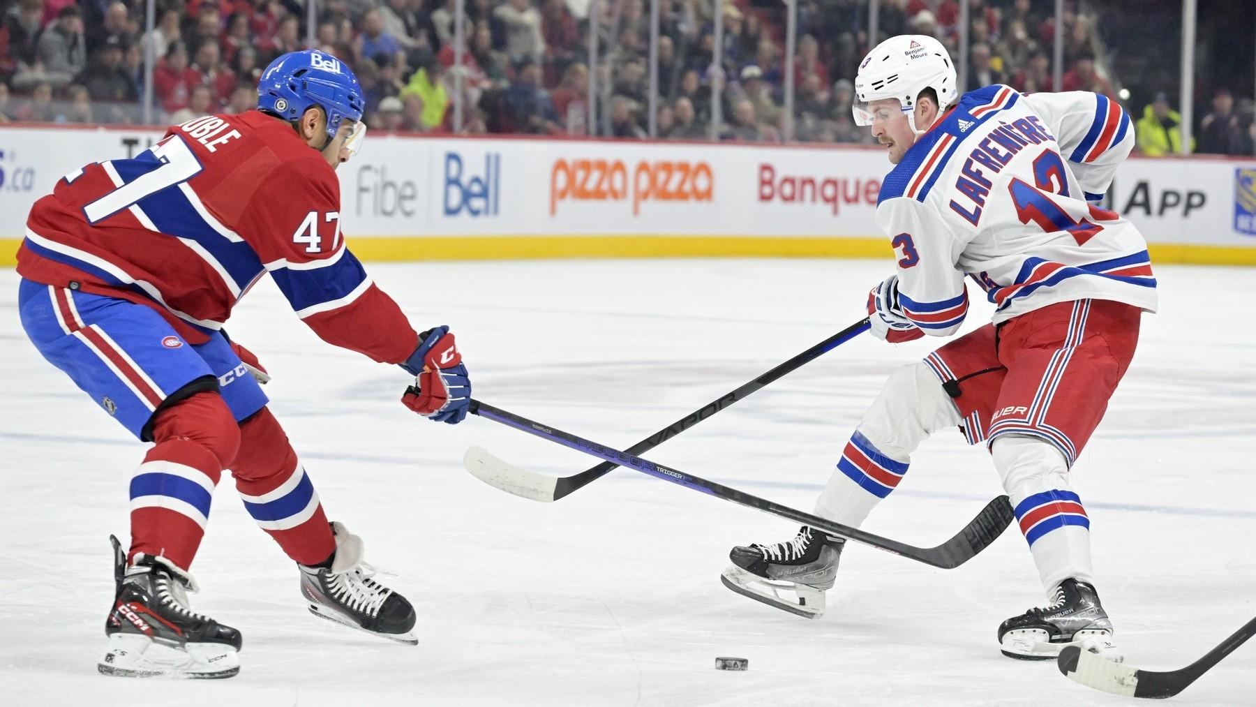 New York Rangers forward Alexis Lafreniere (13) plays the puck and Montreal Canadiens defenseman Jayden Struble (47) defends during the first period at the Bell Centre. / Eric Bolte-USA TODAY Sports