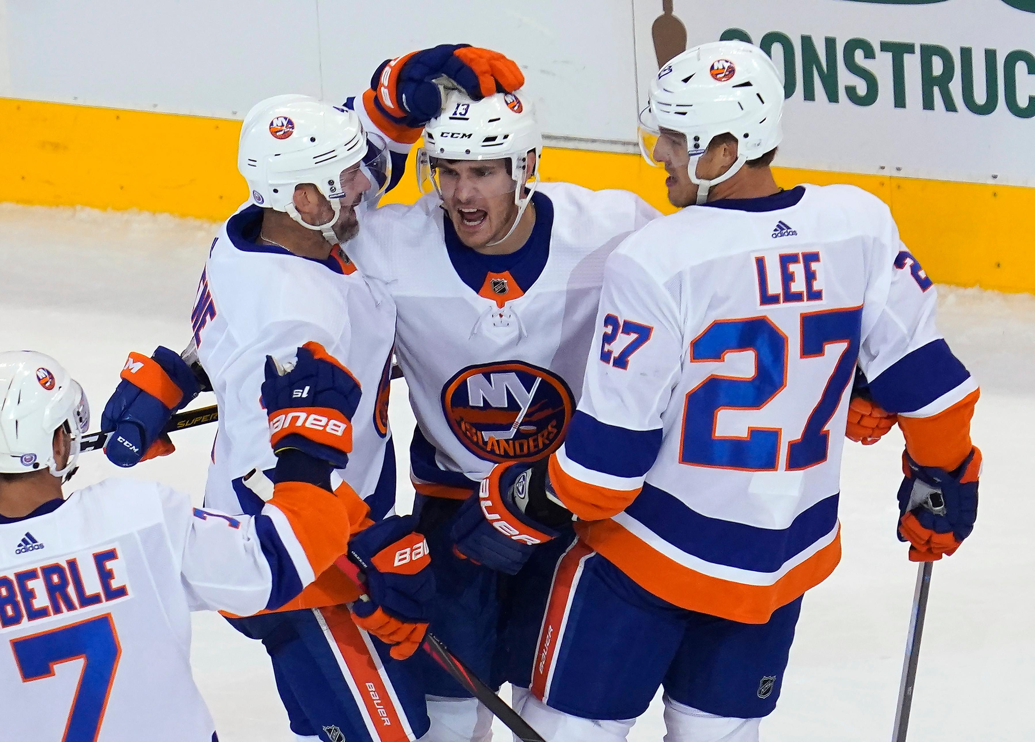 Aug 7, 2020; Toronto, Ontario, CAN; New York Islanders forward Mathew Barzal (13) celebrates his goal against the Florida Panthers with New York Islanders defenseman Andy Greene (4) and forward Anders Lee (27) during the third period of Eastern Conference qualifications at Scotiabank Arena. New York defeated Florida. / John E. Sokolowski/USA TODAY Sports