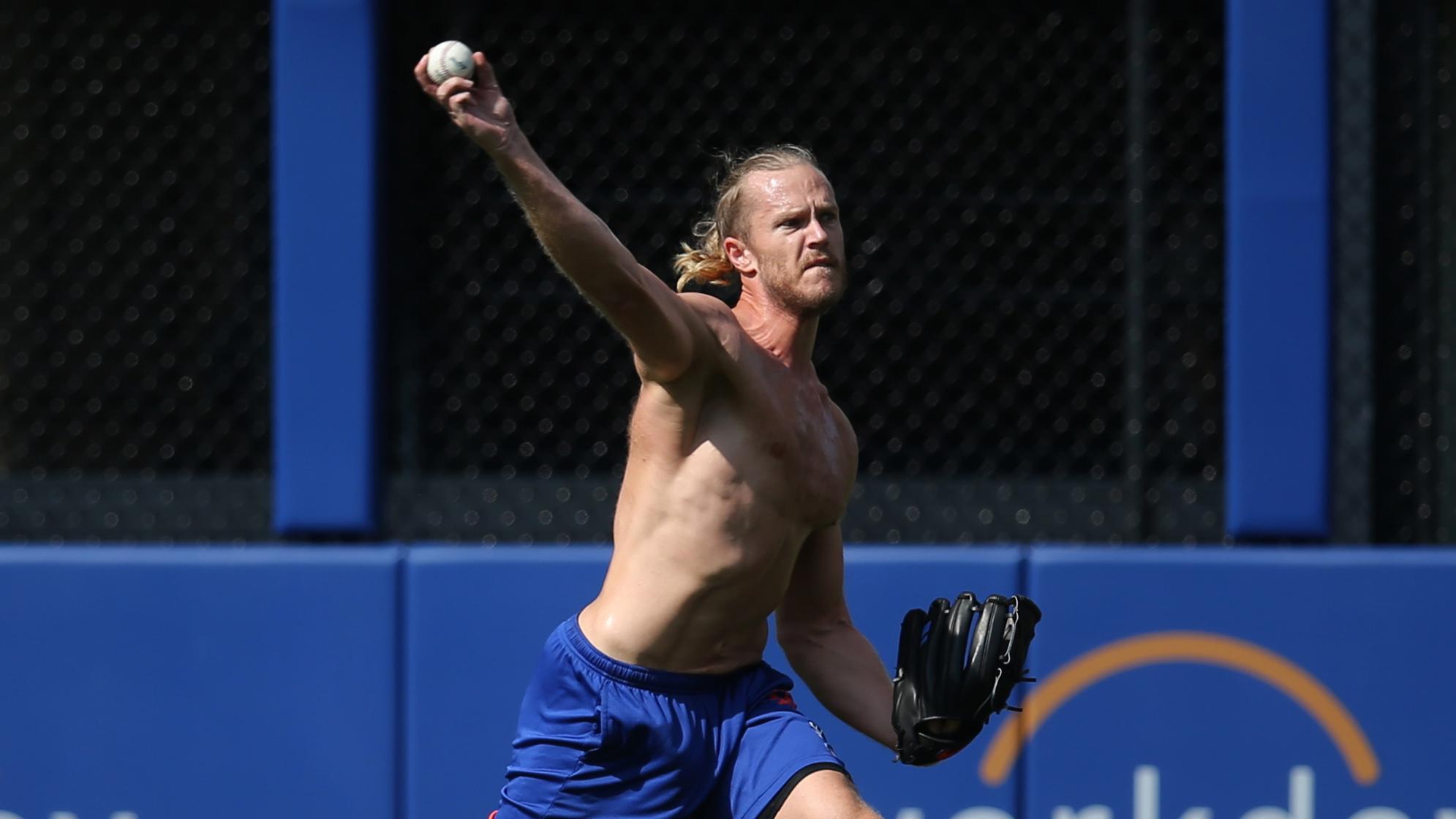 Jul 30, 2021; New York City, New York, USA; New York Mets injured starting pitcher Noah Syndergaard (34) works out in the outfield before a game against the Cincinnati Reds at Citi Field. / Brad Penner-USA TODAY Sports