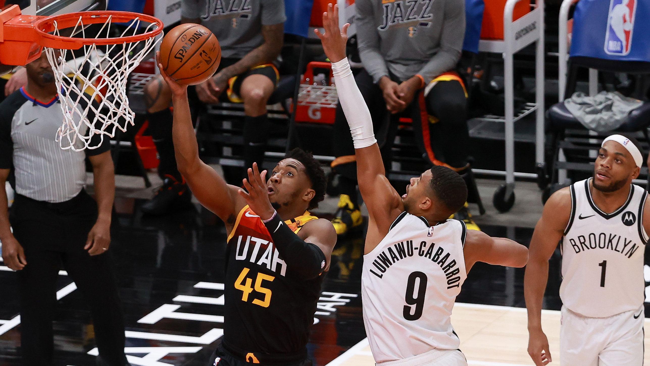 Mar 24, 2021; Salt Lake City, Utah, USA; Utah Jazz guard Donovan Mitchell (45) gets past Brooklyn Nets guard Timothe Luwawu-Cabarrot (9) and to the basket during the first quarter at Vivint Smart Home Arena. / Chris Nicoll-USA TODAY Sports