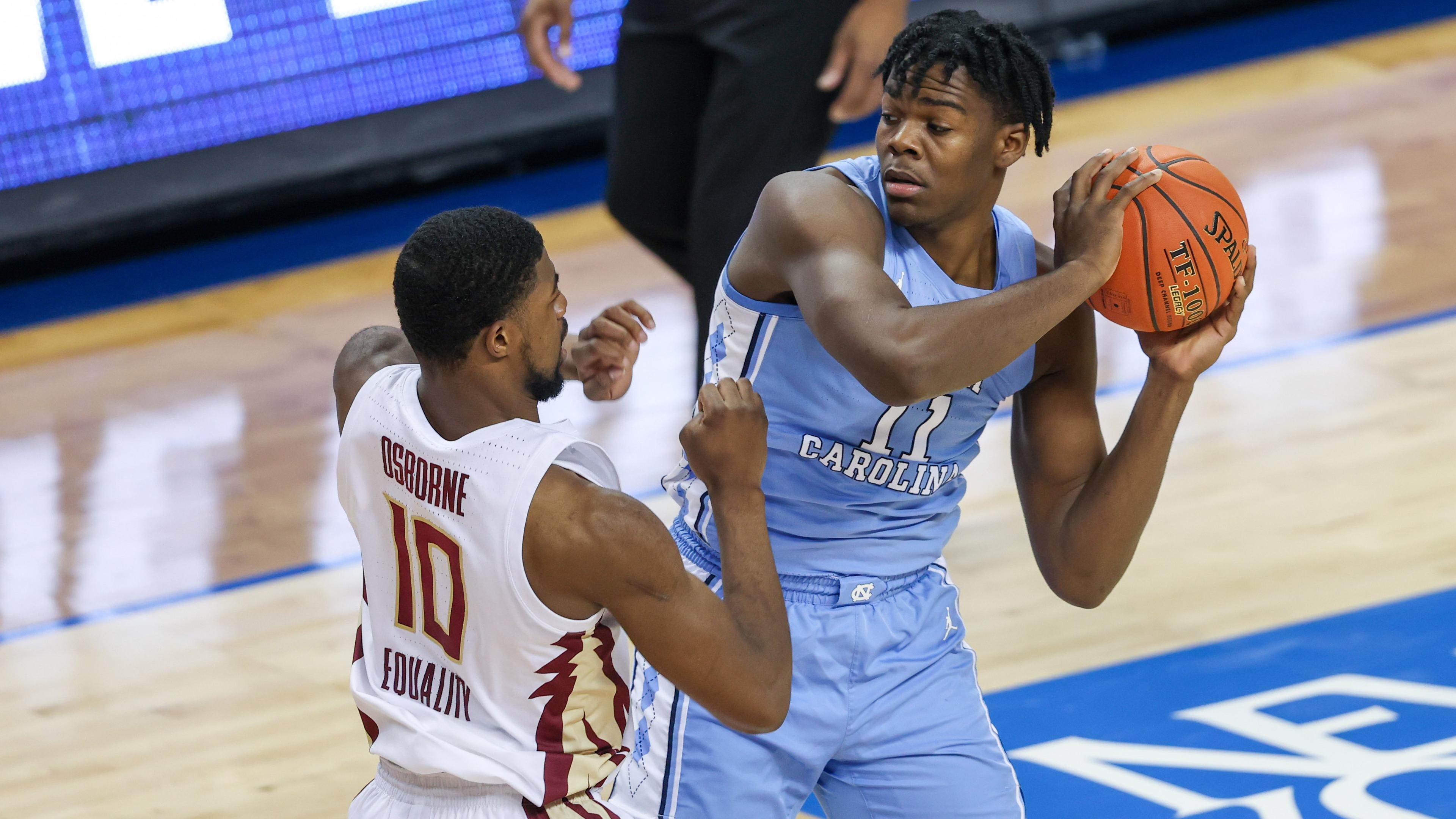 North Carolina Tar Heels forward Day'Ron Sharpe (11) looks to pass against Florida State Seminoles forward Malik Osborne (10) in the first half in the 2021 ACC tournament / Nell Redmond - USA TODAY Sports
