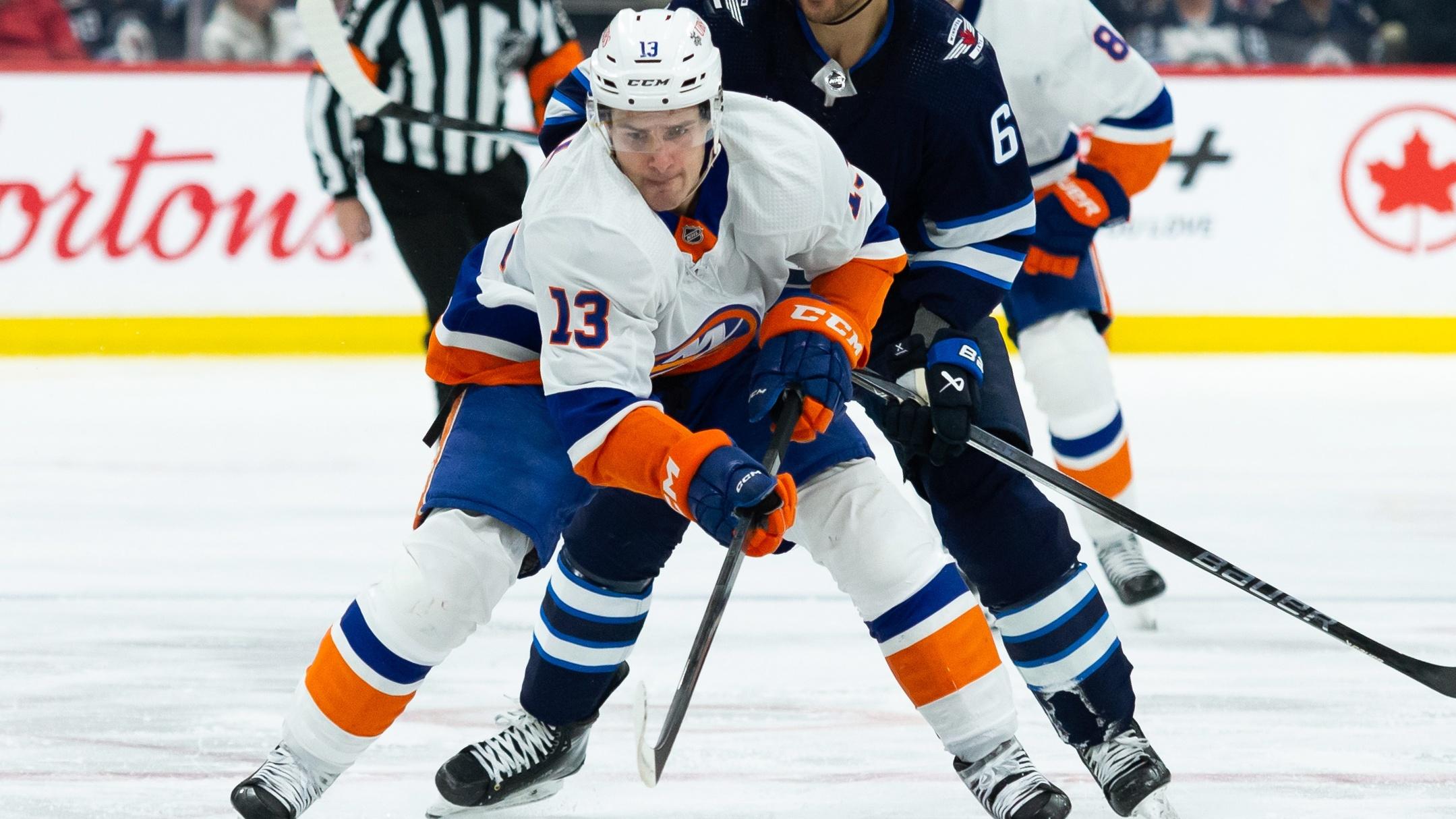 New York Islanders forward Mathew Barzal (13) skates away from Winnipeg Jets forward Nino Niederreiter (62) during the first period at Canada Life Centre / Terrence Lee - USA TODAY Sports