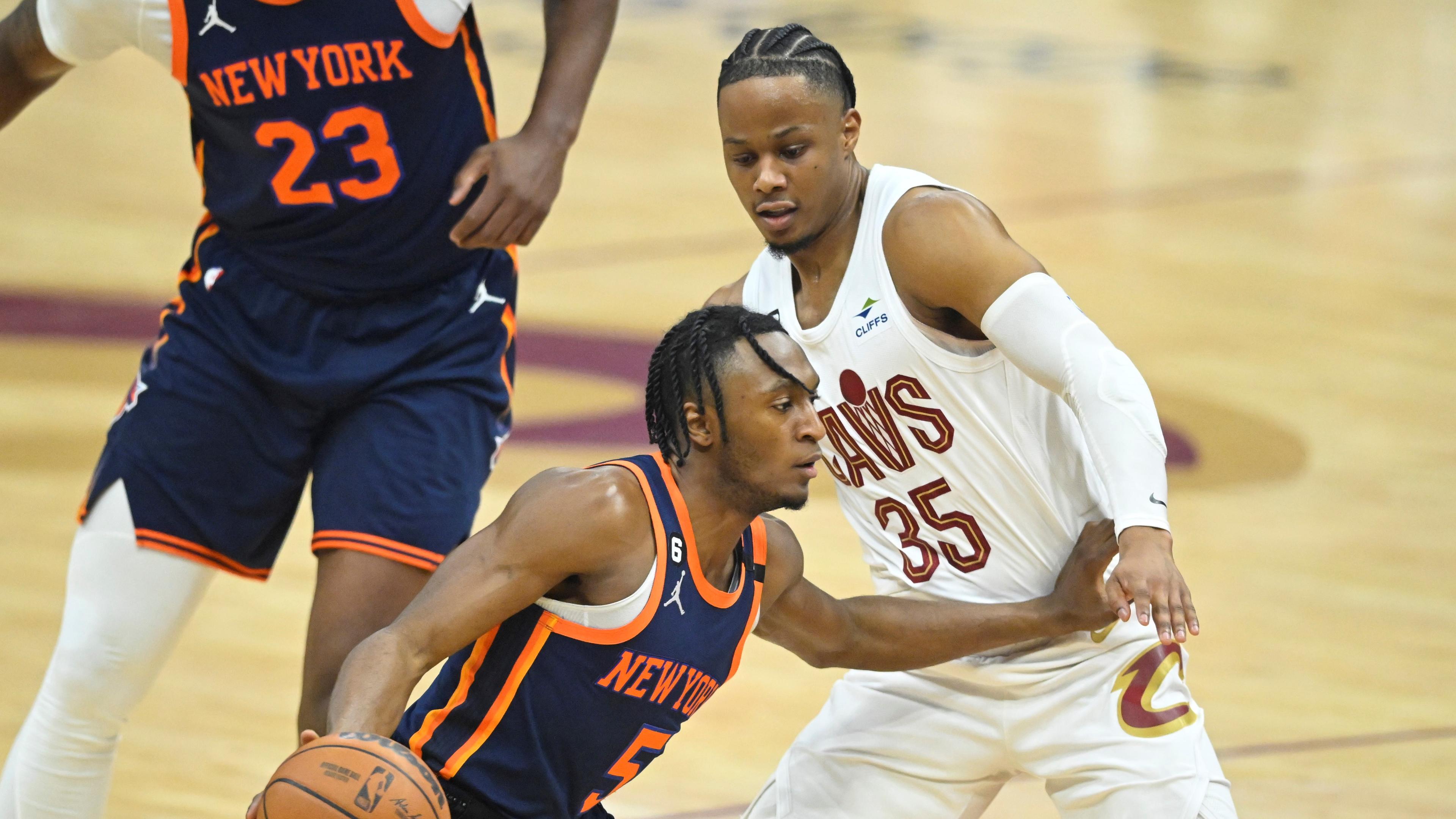 Apr 15, 2023; Cleveland, Ohio, USA; New York Knicks guard Immanuel Quickley (5) dribbles beside Cleveland Cavaliers forward Isaac Okoro (35) in the first quarter of game one of the 2023 NBA playoffs at Rocket Mortgage FieldHouse. Mandatory Credit: David Richard-USA TODAY Sports / © David Richard-USA TODAY Sports