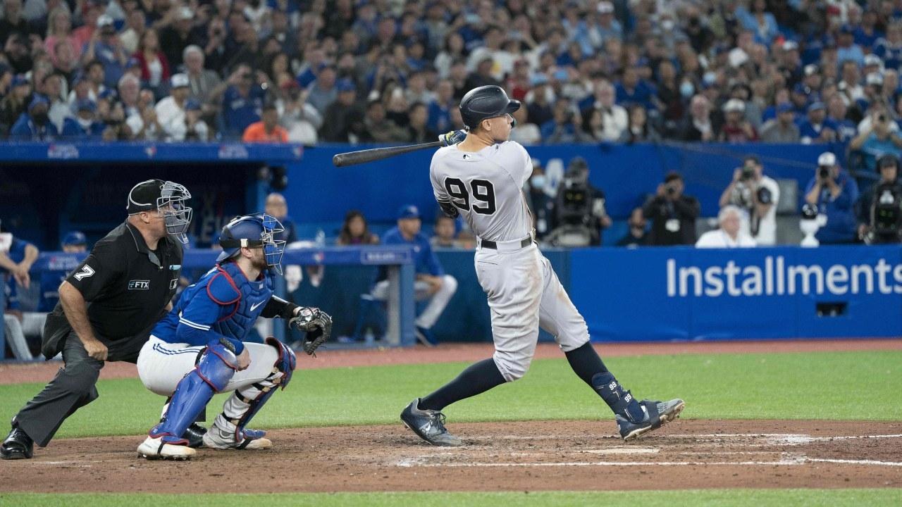 New York Yankees designated hitter Aaron Judge (99) hits his 61st home run scoring two runs against the Toronto Blue Jays during the seventh inning. / Nick Turchiaro-USA TODAY Sports