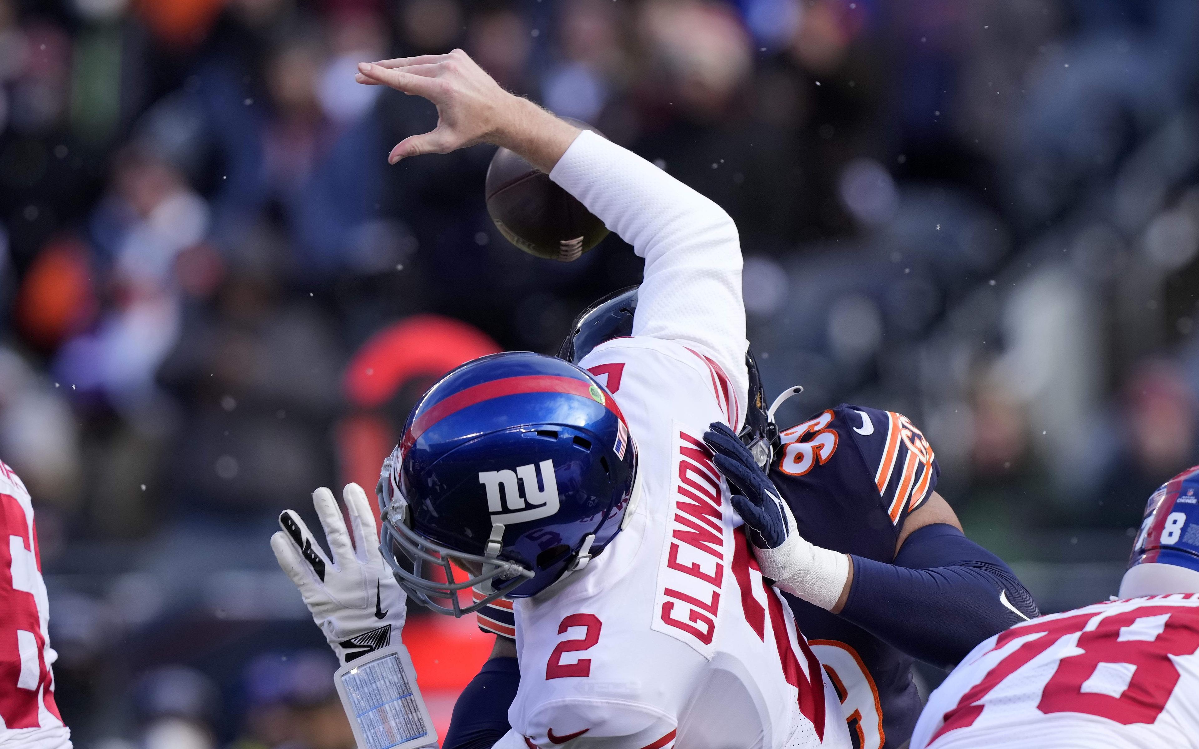 Jan 2, 2022; Chicago, Illinois, USA; New York Giants quarterback Mike Glennon (2) fumbles the ball after being hit by Chicago Bears outside linebacker Trevis Gipson (99) during the first quarter at Soldier Field. Mandatory Credit: Mike Dinovo-USA TODAY Sports / © Mike Dinovo-USA TODAY Sports