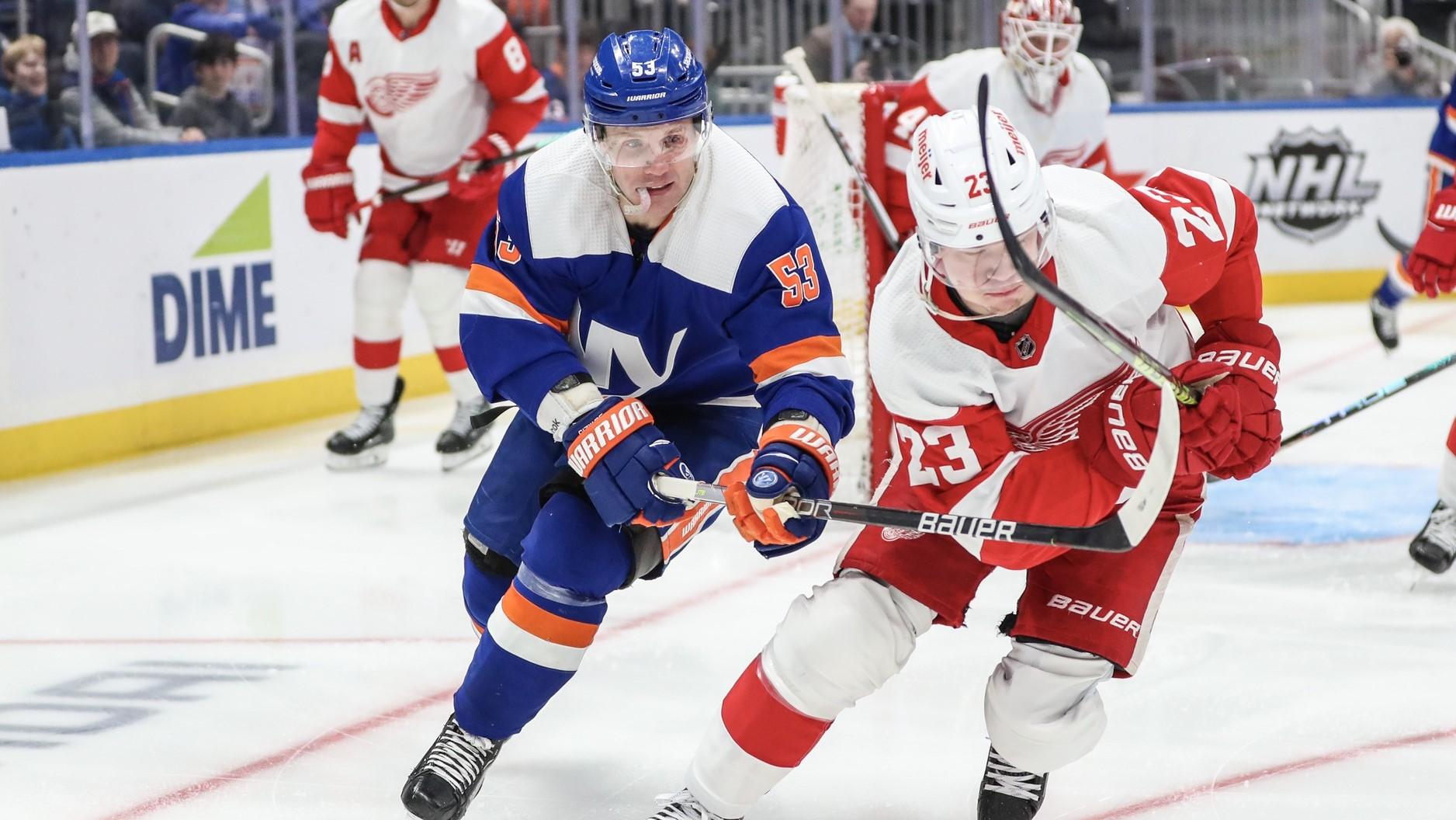 Mar 4, 2023; Elmont, New York, USA; New York Islanders center Casey Cizikas (53) and Detroit Red Wings left wing Lucas Raymond (23) chase after the puck in the second period at UBS Arena. / Wendell Cruz-USA TODAY Sports