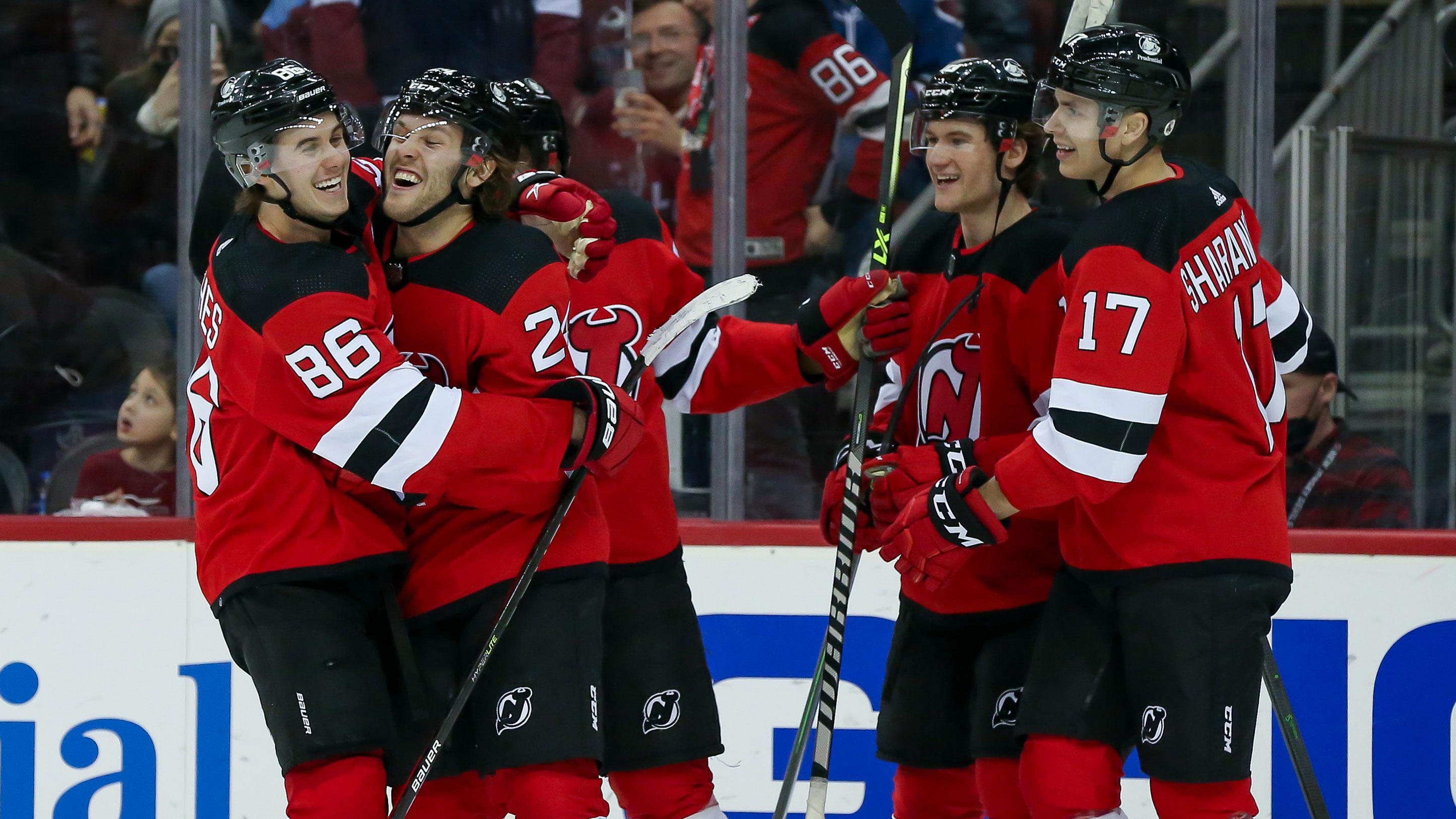 Mar 8, 2022; Newark, New Jersey, USA; New Jersey Devils defenseman Ty Smith (24) celebrates with New Jersey Devils center Jack Hughes (86), New Jersey Devils center Dawson Mercer (18) and New Jersey Devils center Yegor Sharangovich (17) after scoring a goal against Colorado Avalanche during the second period at Prudential Center. / Tom Horak-USA TODAY Sports