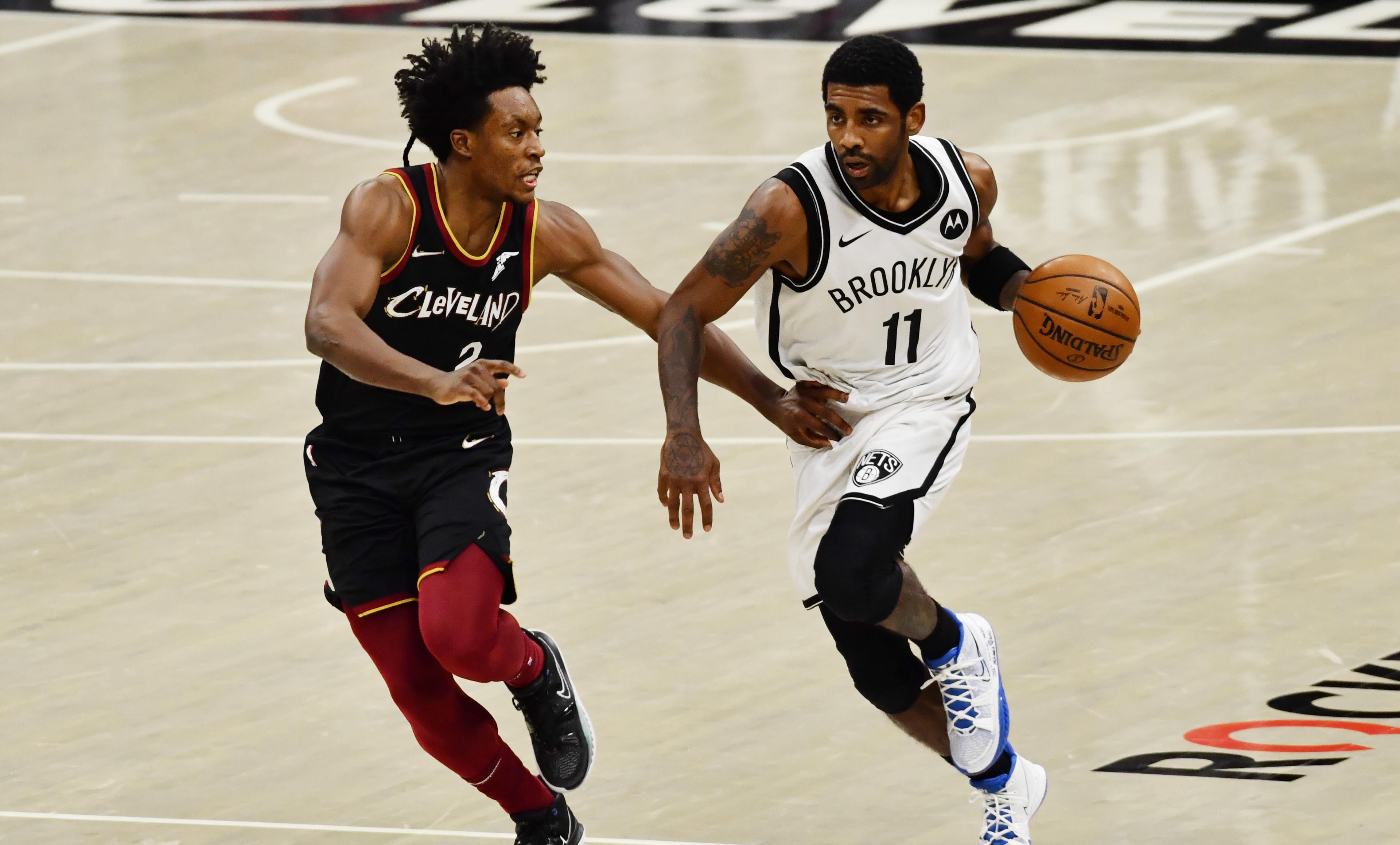 Jan 22, 2021; Cleveland, Ohio, USA; Brooklyn Nets guard Kyrie Irving (11) dribbles the ball up court as Cleveland Cavaliers guard Collin Sexton (2) defends during the third quarter at Rocket Mortgage FieldHouse. / Ken Blaze-USA TODAY Sports