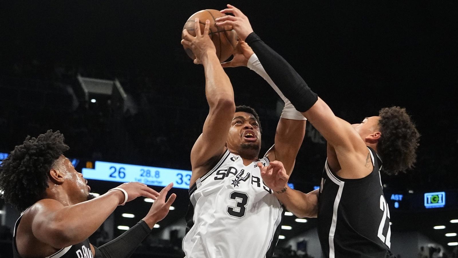 Brooklyn Nets forward Jalen Wilson (22) fouls San Antonio Spurs small forward Keldon Johnson (3) taking a shot during the first half at Barclays Center. / Gregory Fisher-USA TODAY Sports