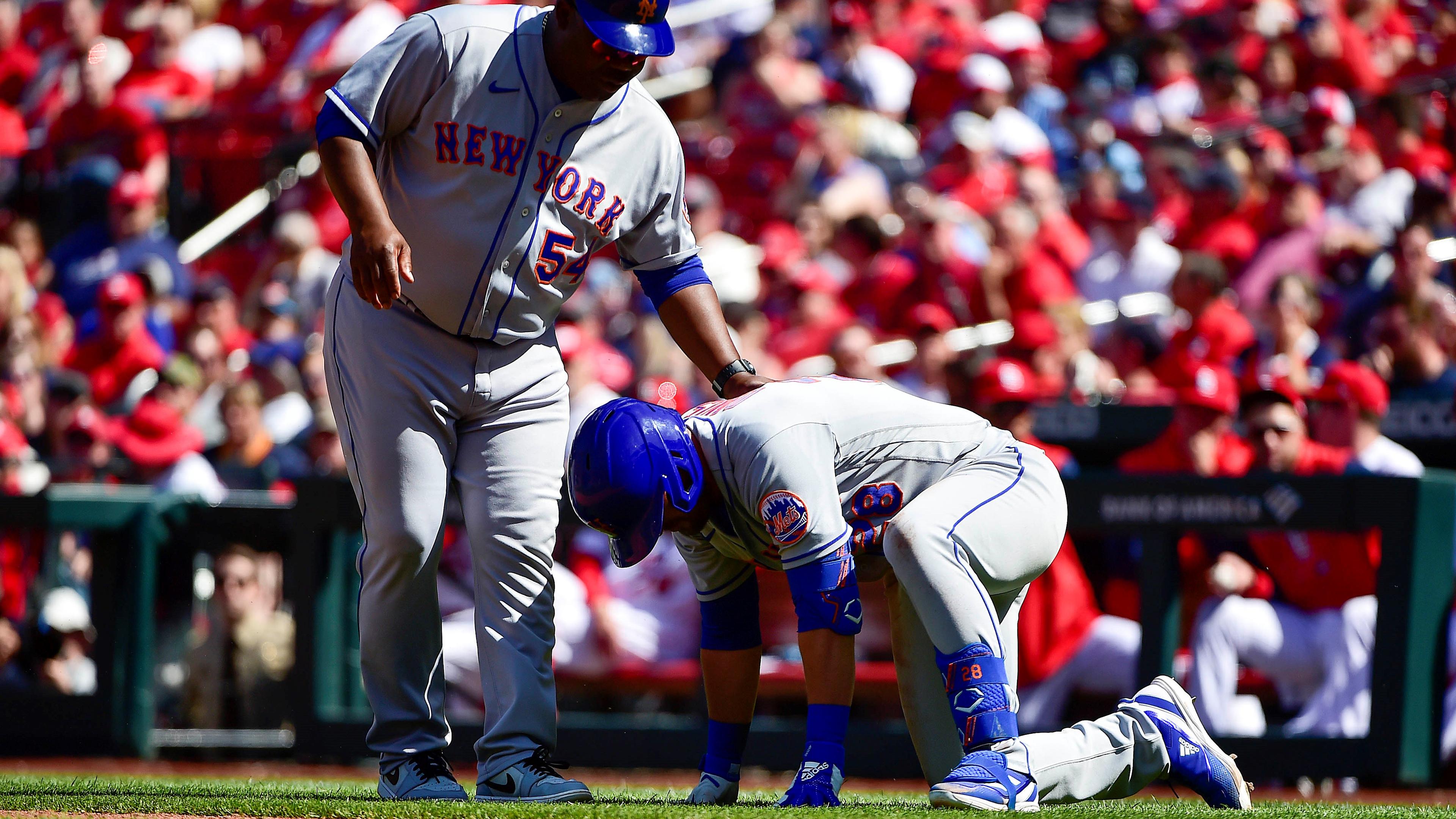 New York Mets third baseman J.D. Davis (28) is checked on by first base coach Wayne Kirby (54) after he was hit in the foot by a pitch / Jeff Curry- USA TODAY Sports