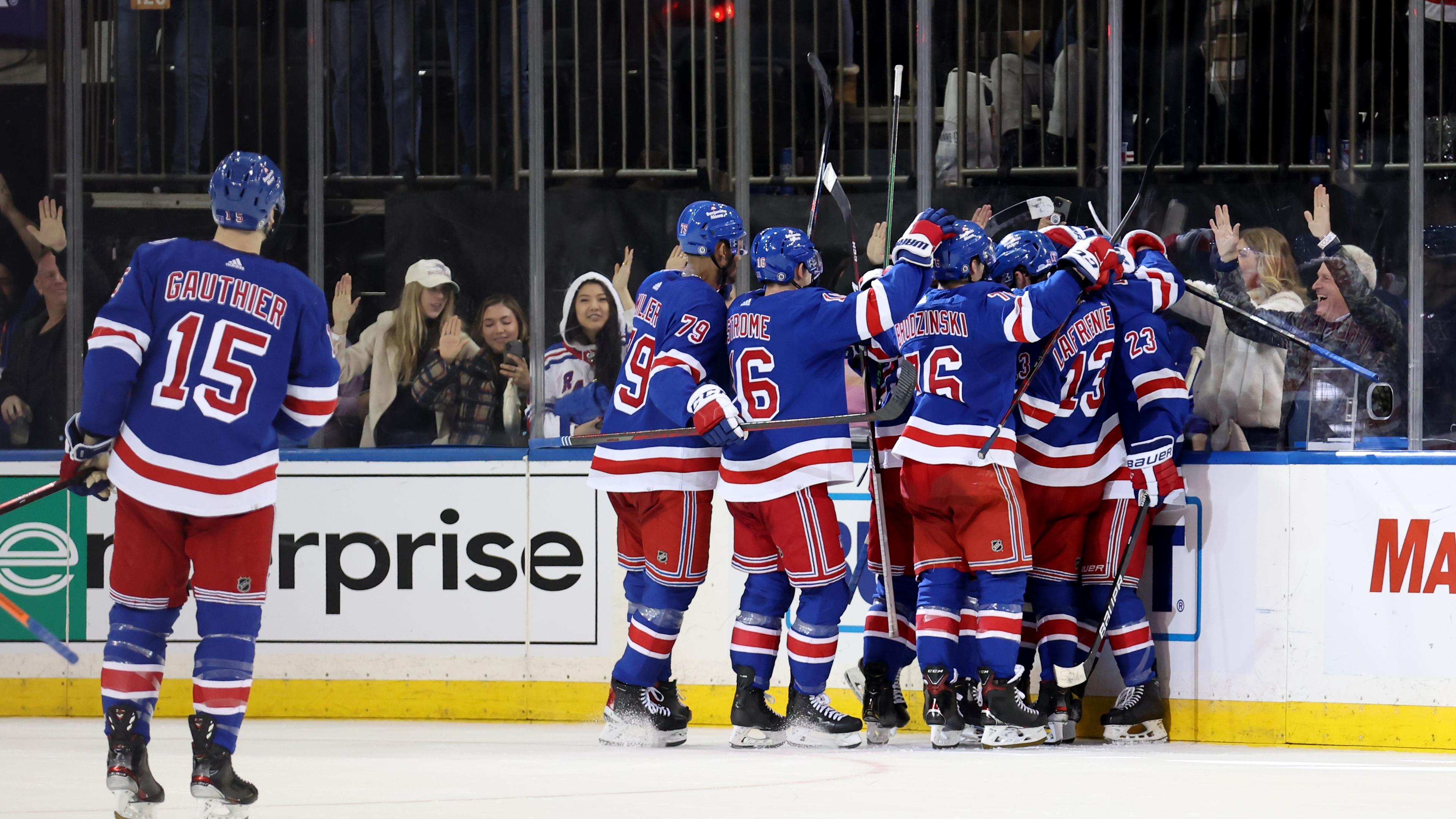 Mar 15, 2022; New York, New York, USA; New York Rangers defenseman Adam Fox (23) celebrates his game winning goal against the Anaheim Ducks with teammates during overtime at Madison Square Garden / Brad Penner-USA TODAY Sports