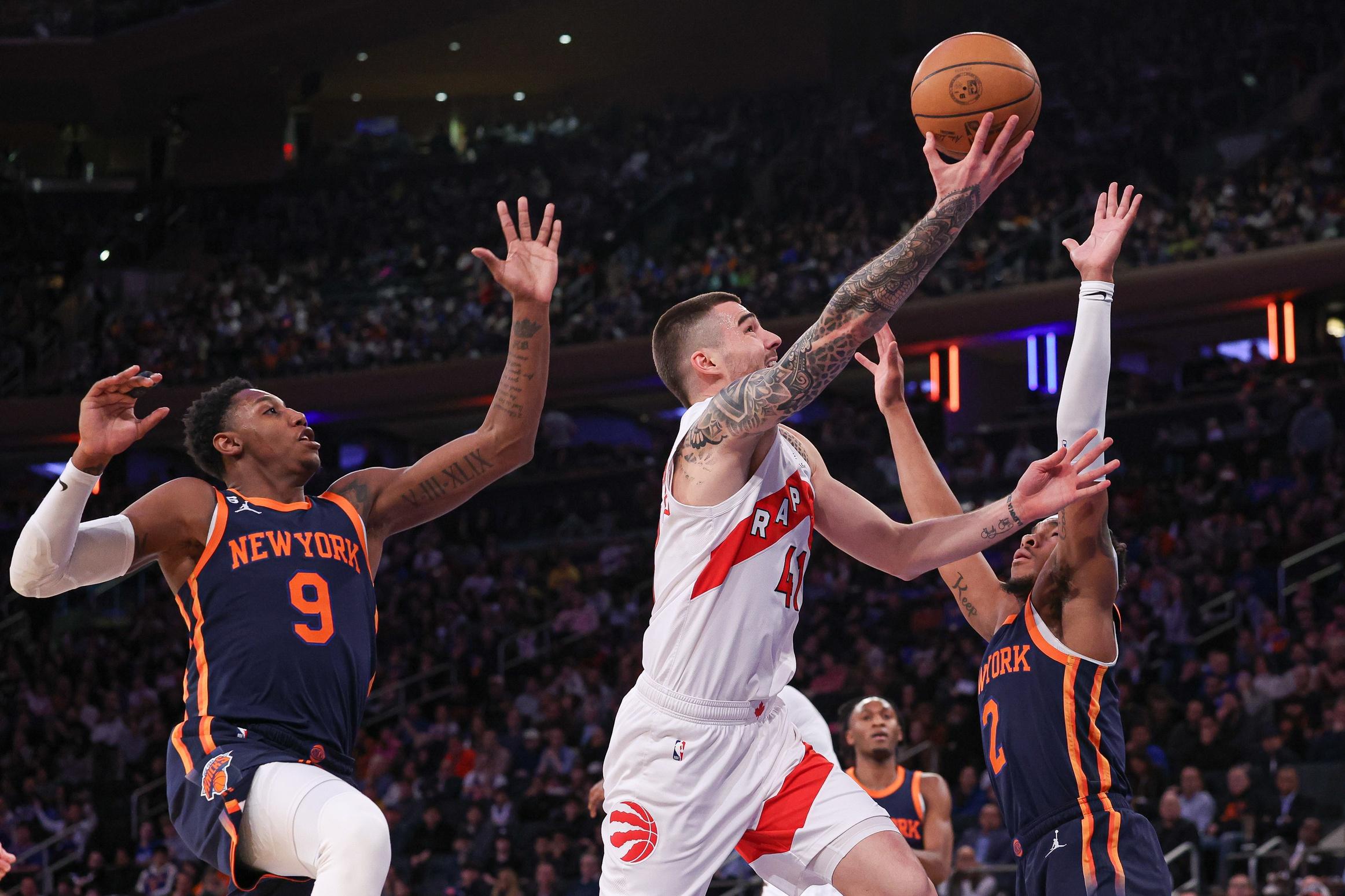 Toronto Raptors forward Juancho Hernangomez (41) drives to the basket as New York Knicks guard RJ Barrett (9) and guard Miles McBride (2) defend during the first half at Madison Square Garden. / Vincent Carchietta-USA TODAY Sports